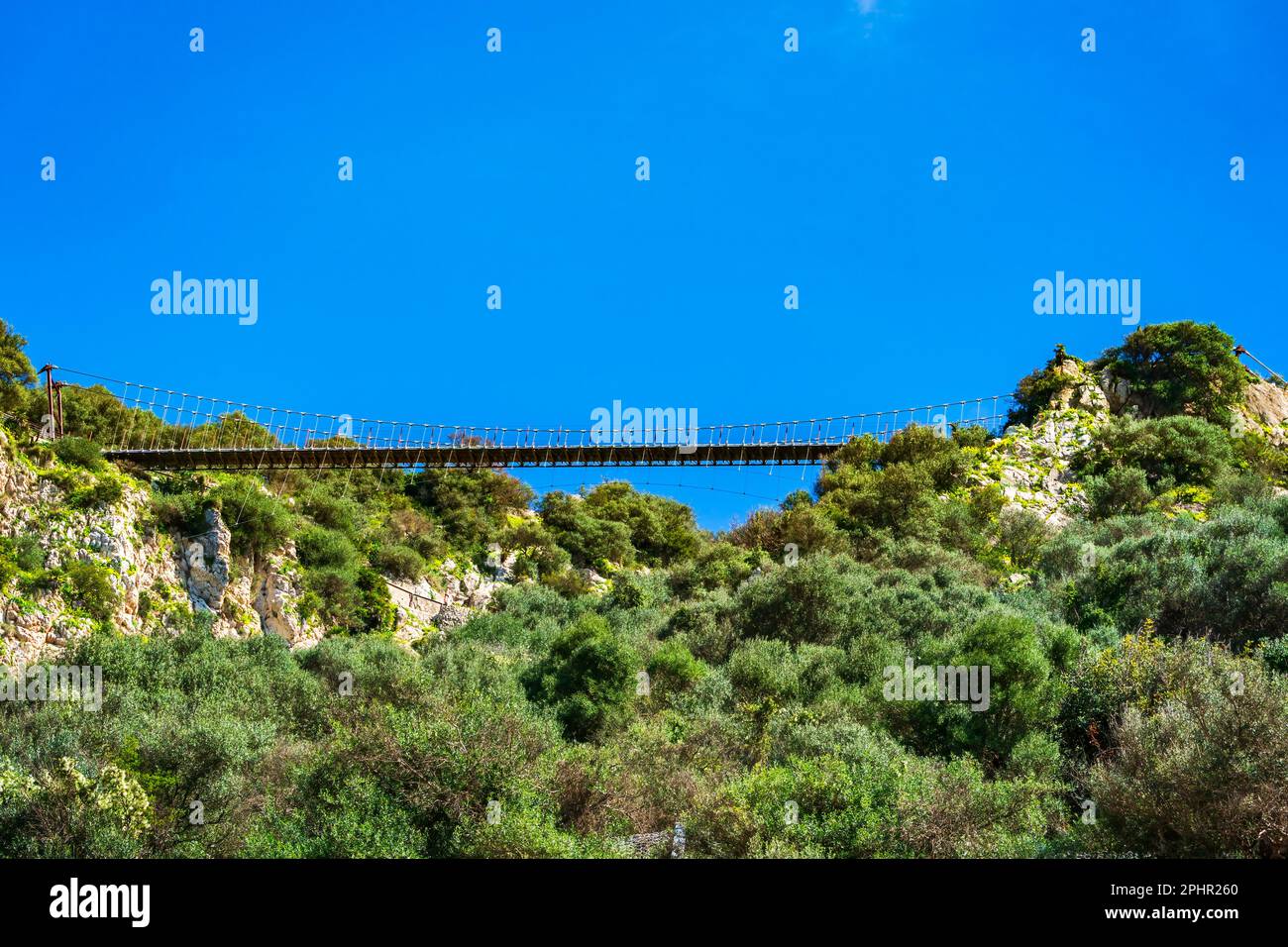 Panoramic view of the 70m-long pedestrian Windsor Bridge - a suspension bridge on the Upper Rock in Gibraltar Stock Photo