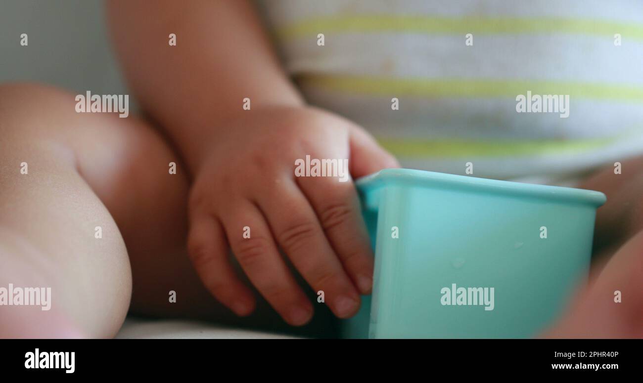 Closeup of baby hands snacking, infant toddler hand grabbing fruit ...