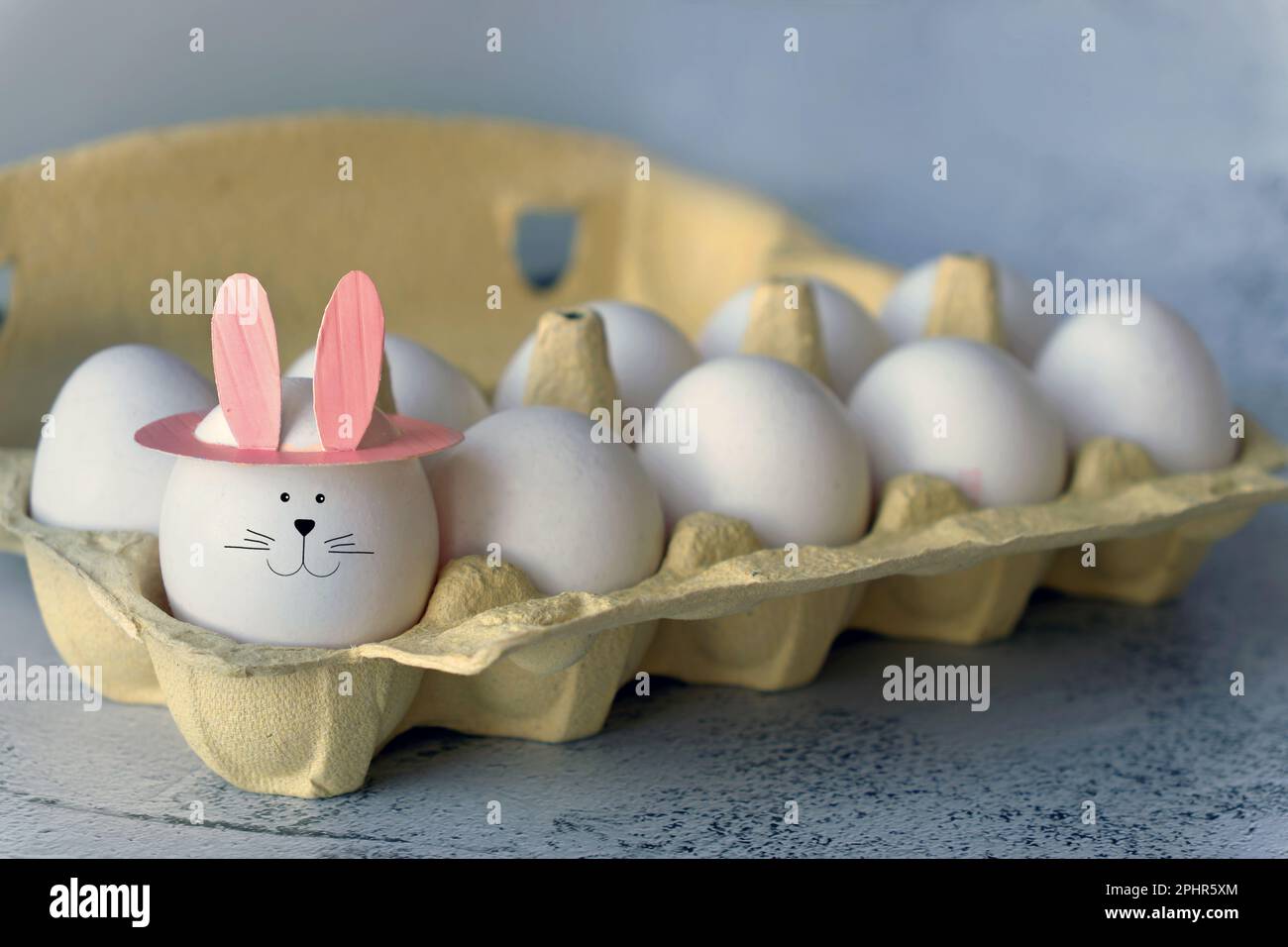 funny egg with bunny ears in tray Stock Photo