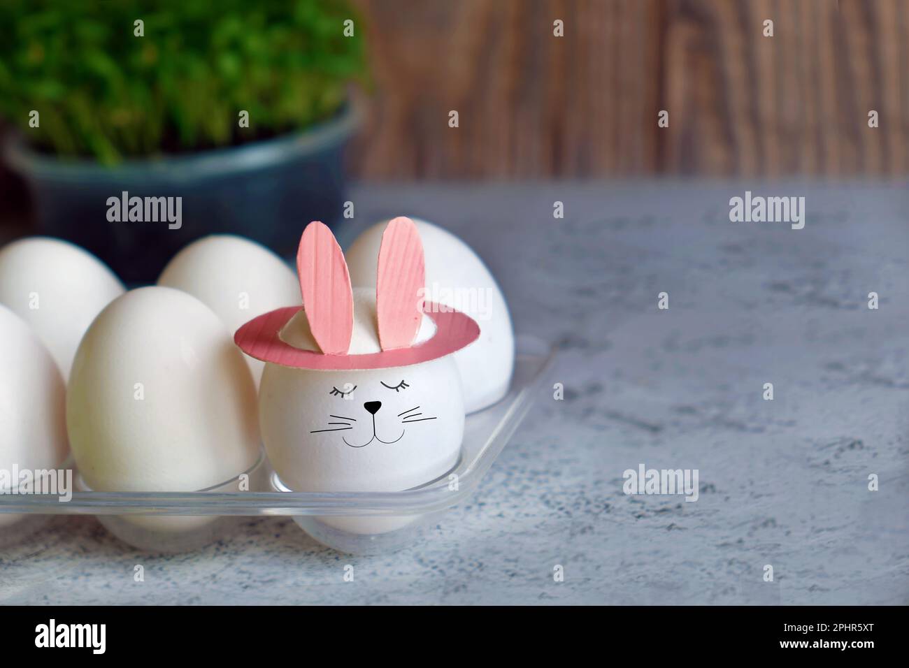funny egg with bunny ears in tray Stock Photo