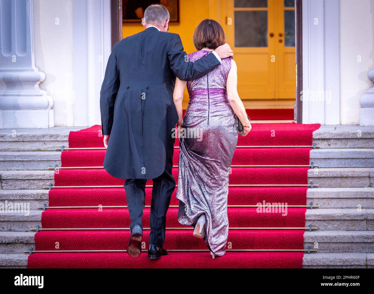 Berlin, Germany. 29th Mar, 2023. Friedrich Merz, head of the CDU parliamentary group in the Bundestag, and his wife Charlotte arrive at Bellevue Palace, the official residence of the German president, for a state banquet with the British royal couple. Before his coronation in May 2023, the British king and royal wife will visit Germany for three days. Credit: Jens Büttner/dpa/Alamy Live News Stock Photo