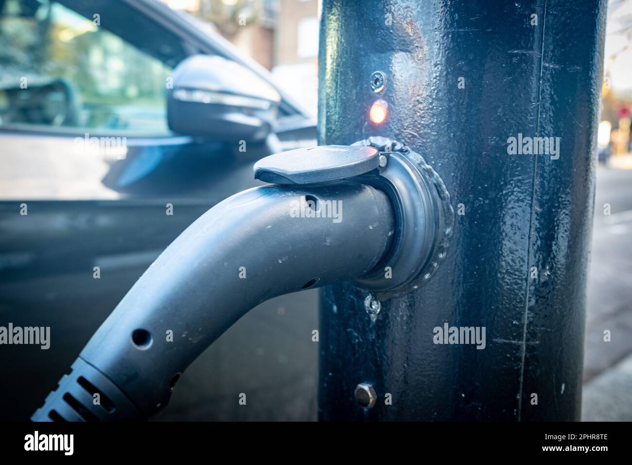 London- January 2023: Electric car charging cable in a retro fitted lamp post in West London Stock Photo