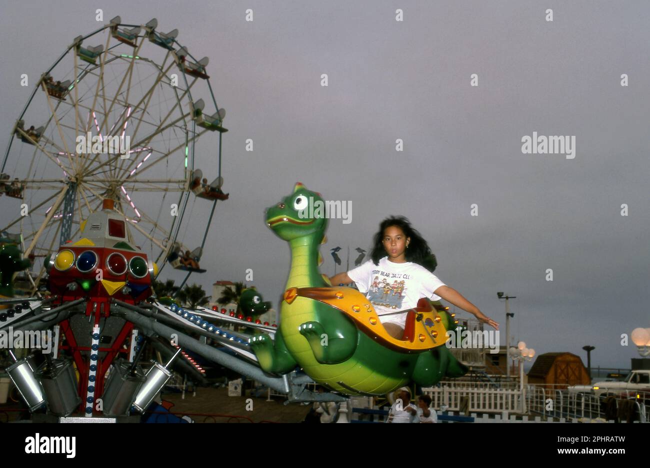 A young girl enjoys a ride at the Santa Monica Pier Fun Zone, Santa