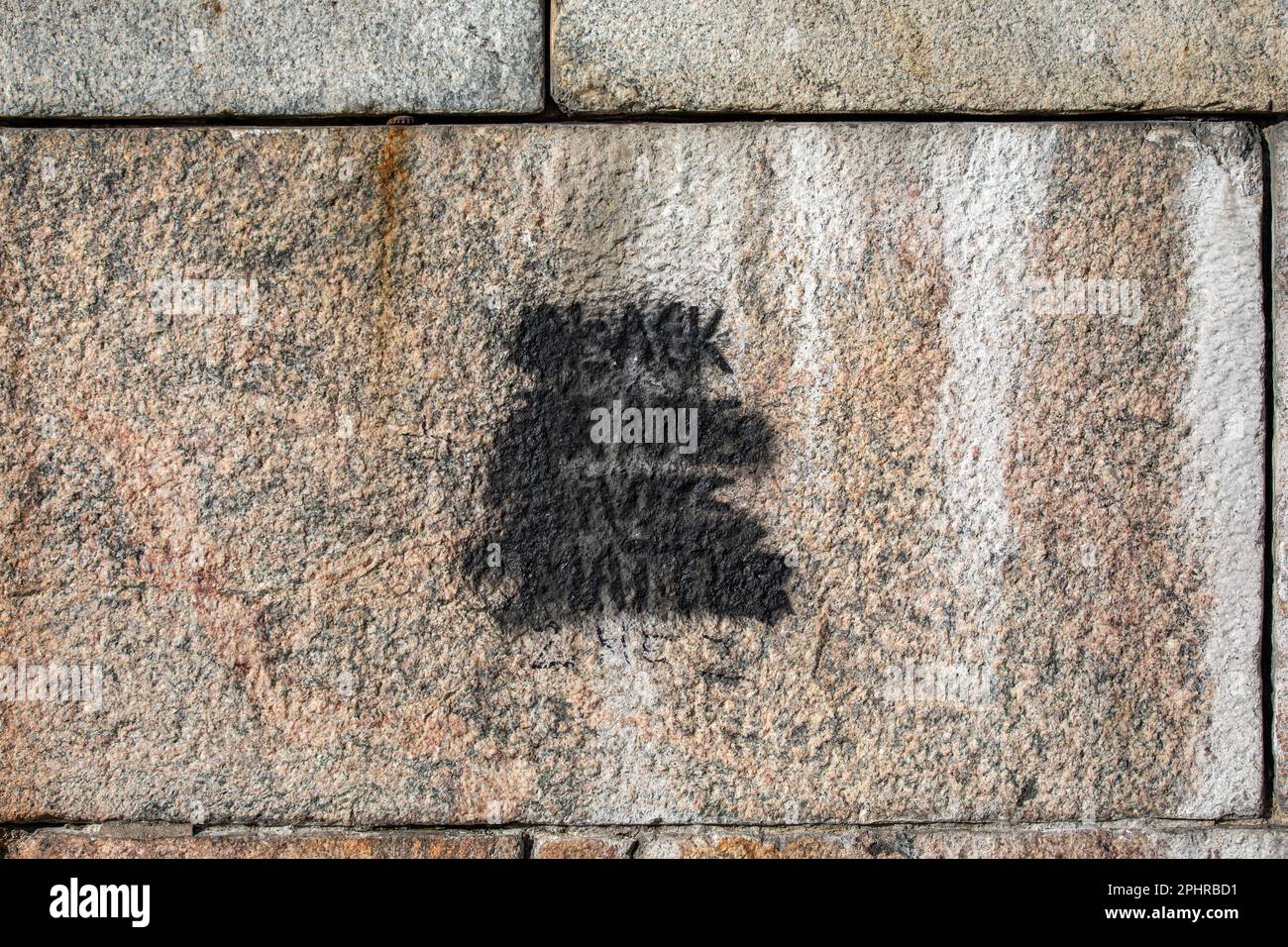 Black Trans Lives Matter stencil graffiti overpainted with black spray paint on Helsinki Cathedral wall in Kruununhaka district of Helsinki, Finland Stock Photo