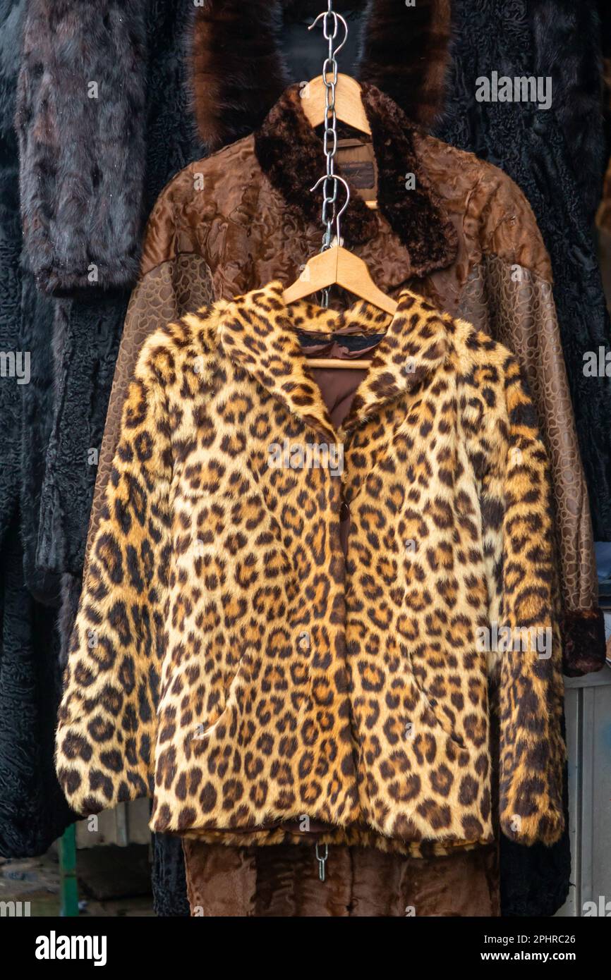 Real fur female coat with leopard print sold on outdoors market Stock Photo