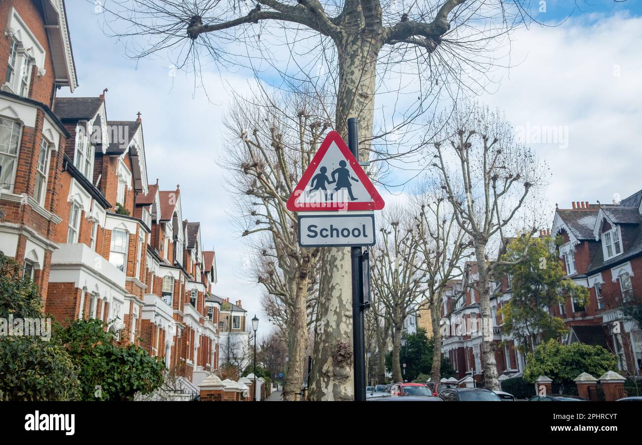 London- January 2023: Triangle warning sign of school crossing in residential area of W10 west London- North Kensington Stock Photo
