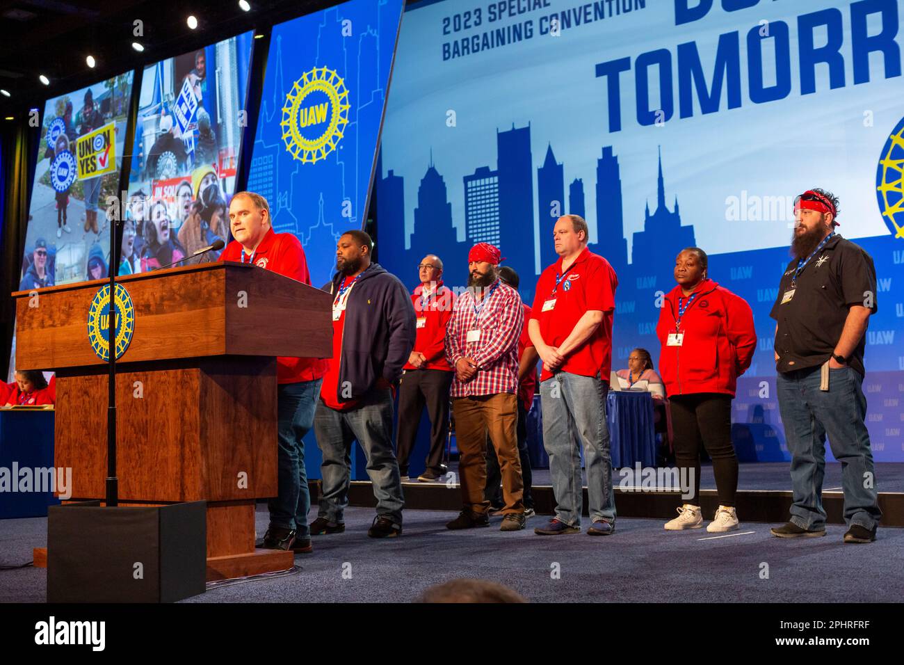 Detroit, Michigan, USA. 29th Mar, 2023. Kevin Logan, president of United Auto Workers Local 1268 and members of his local on stage during the UAW's bargaining convention. The local union's 1,350 workers at Stellantis' Belvidere, Illinois Jeep assembly plant are out of work, they were laid off indefinitely when the plant stopped operations March 1. Job security is one of the union's primary goals in this year's contract bargaining. Credit: Jim West/Alamy Live News Stock Photo