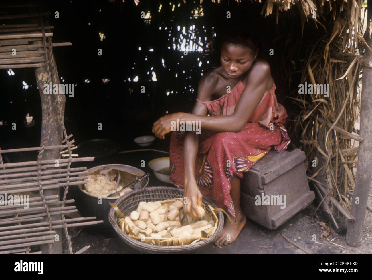 Girl or Libinza ethnic group paring manioc. .Africa, Democratic Republic of the Congo, Ngiri River area. Stock Photo