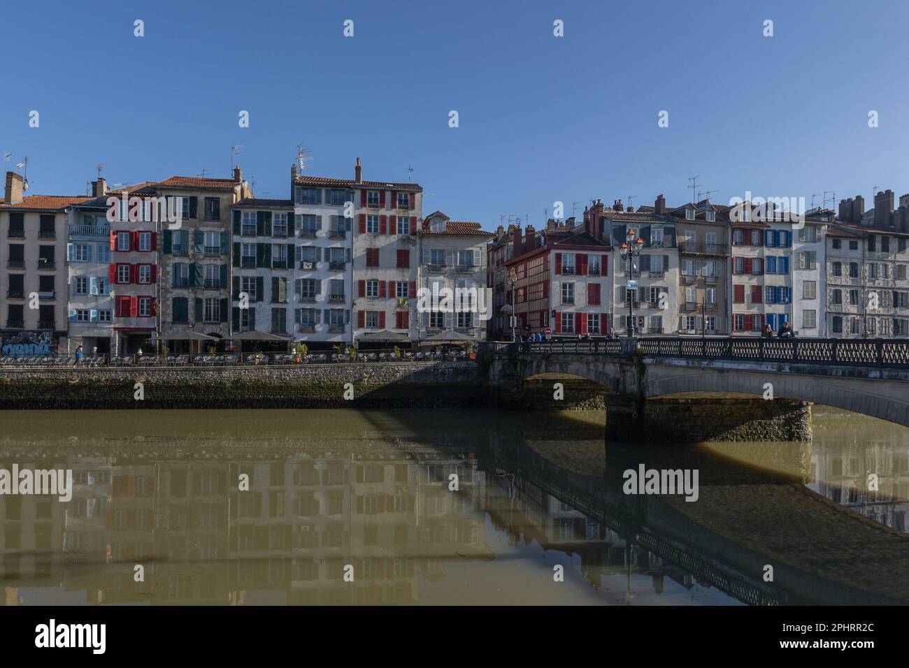 colourful houses across the canal in Bayonne France with the bridge on