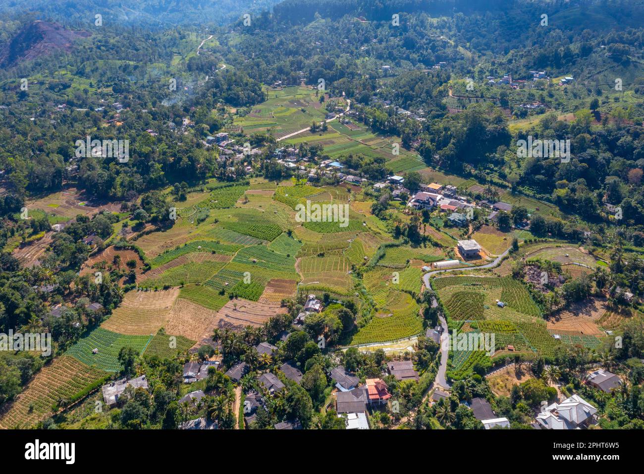 Hilly landscape of Sri Lanka dotted with villages and tea plantations ...