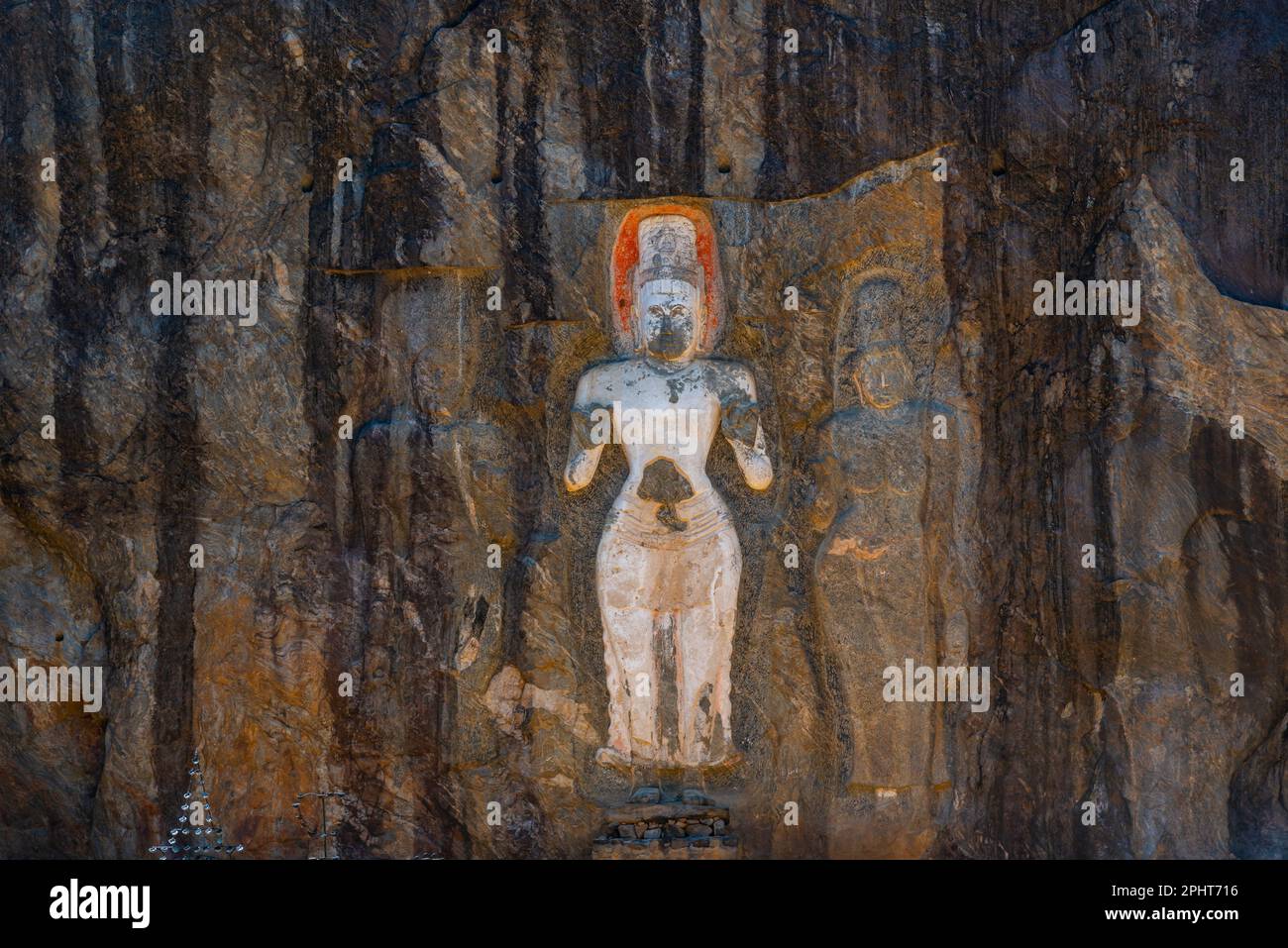 Buddha statues carved into stone at buduruwagala ancient site at Sri