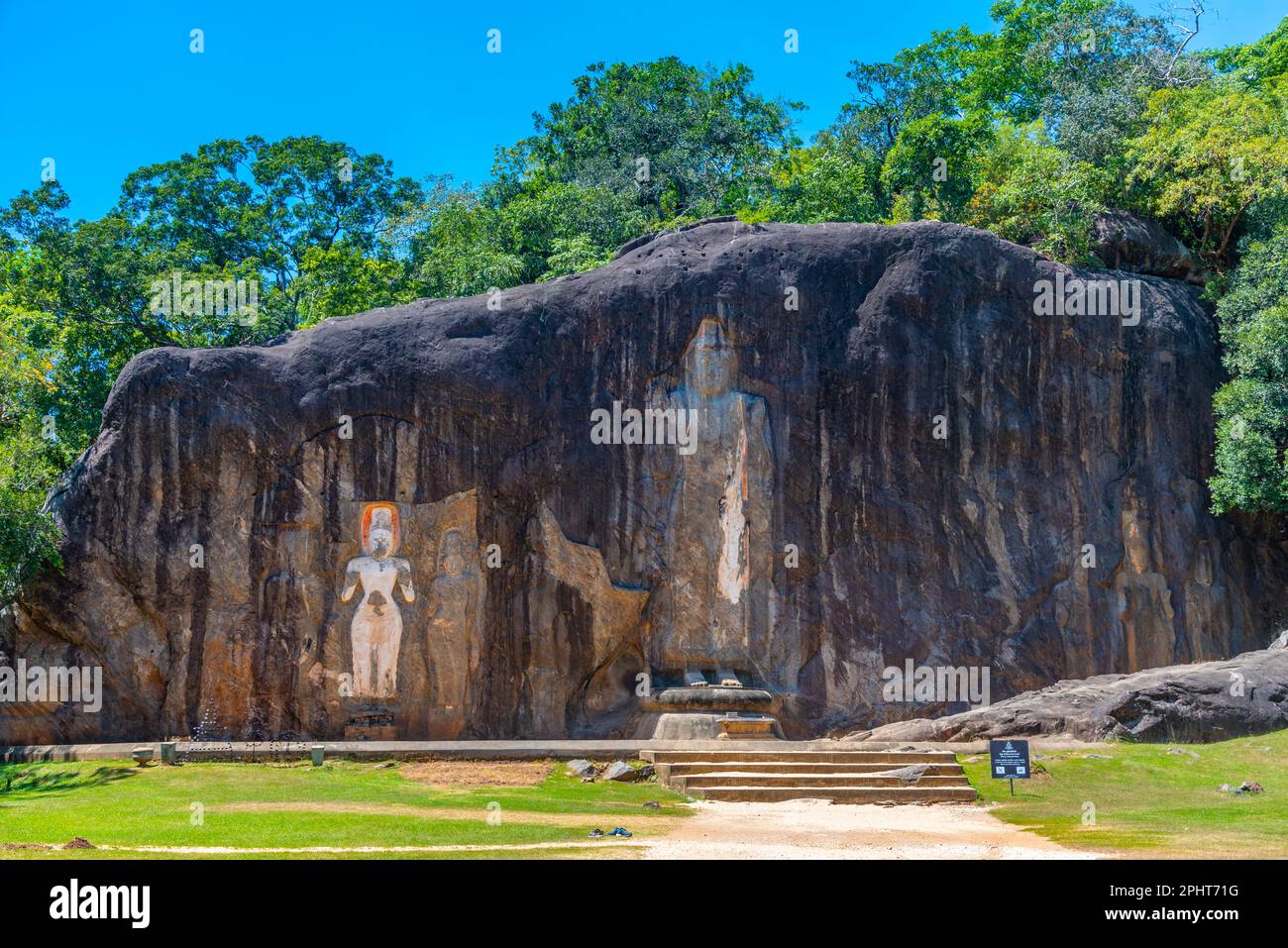Buddha statues carved into stone at buduruwagala ancient site at Sri