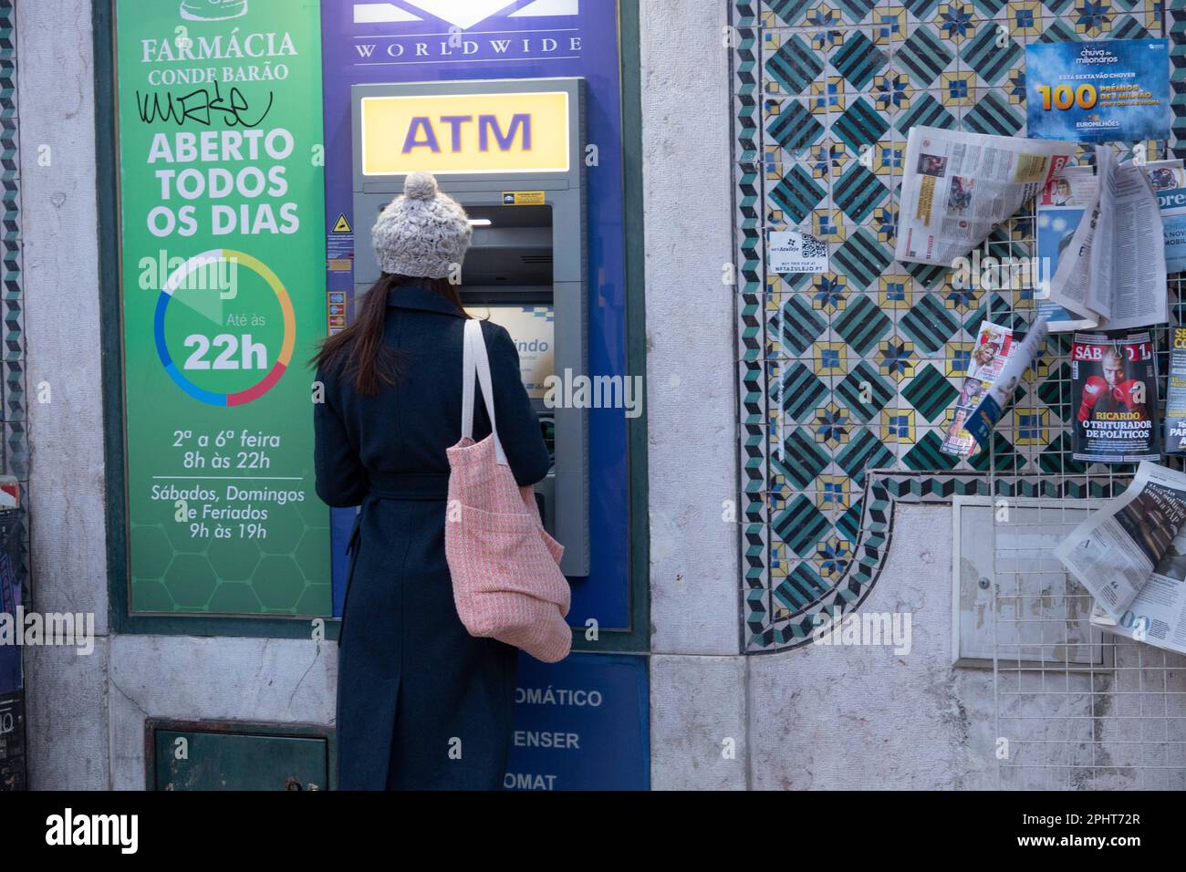 Girl withdrawing money at an ATM. Stock Photo
