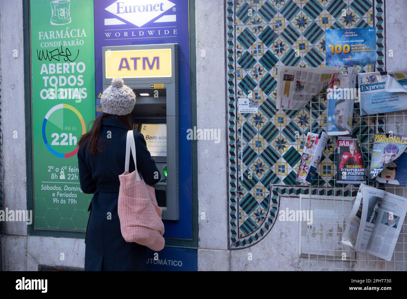 Girl withdrawing money at an ATM. Stock Photo