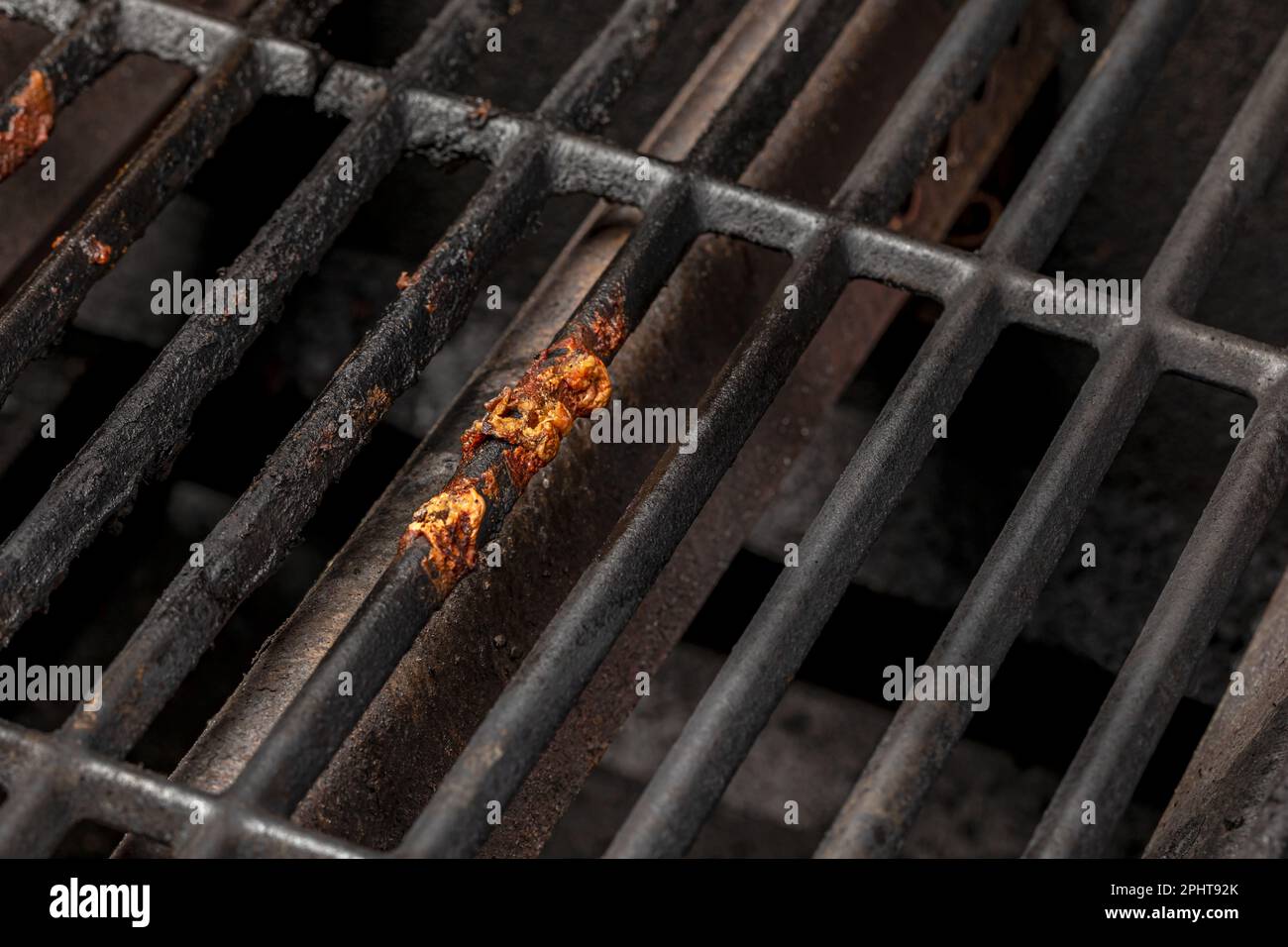 Burnt food stuck on dirty barbecue grill grates. Barbeque grilling
