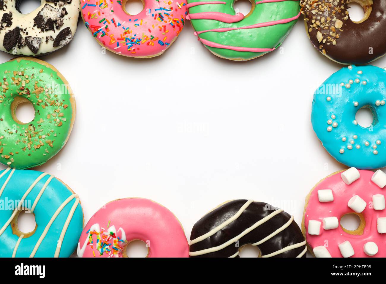 Different delicious glazed doughnuts on white background, top view ...