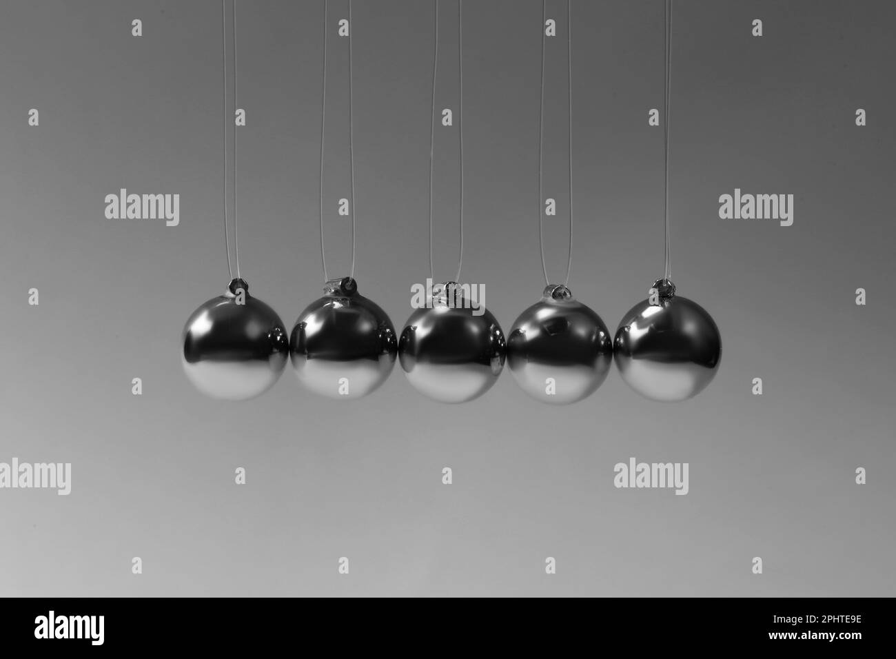 Newton's cradle on grey background. Physics law of energy conservation ...