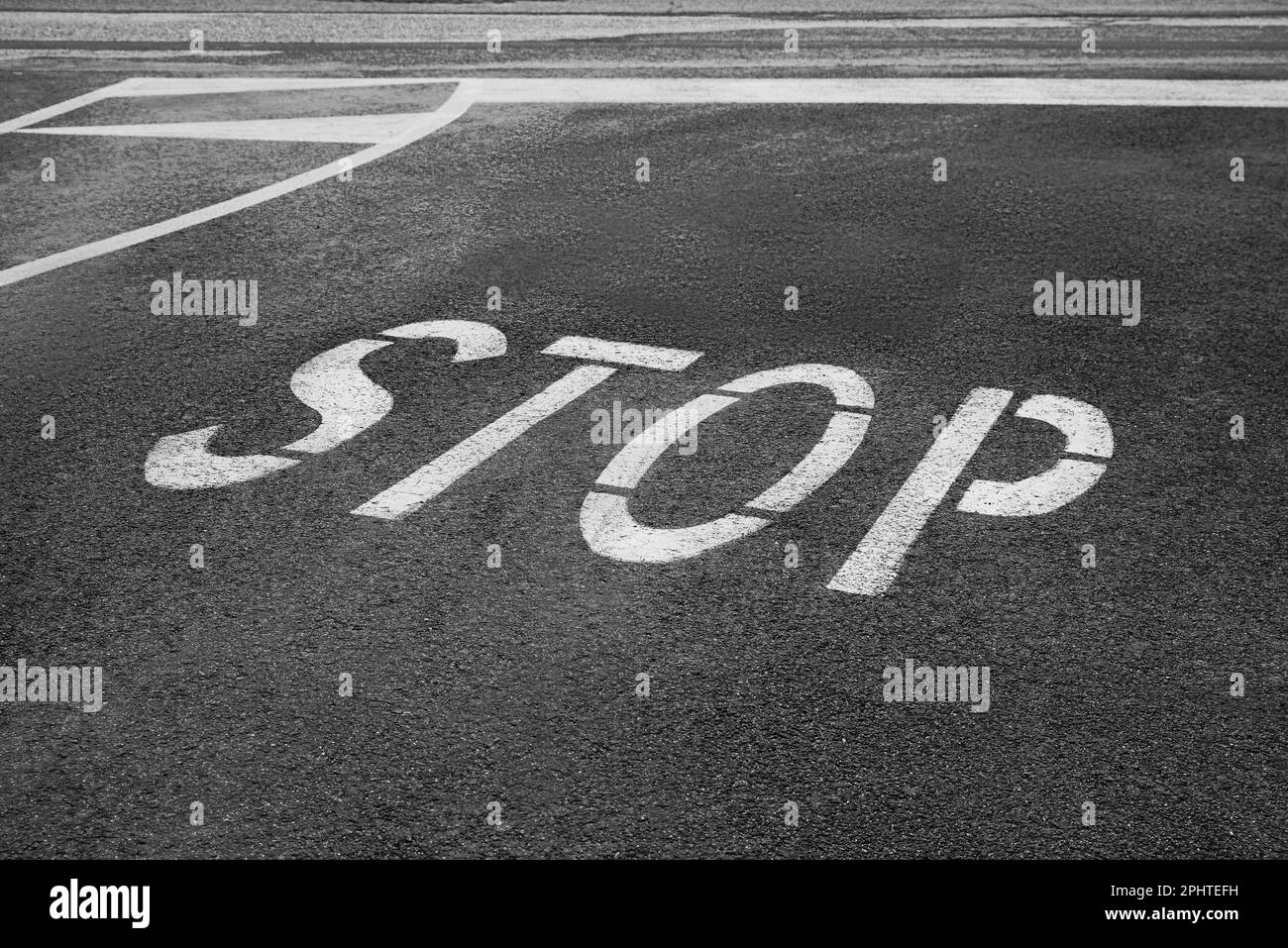 White sign STOP written on asphalt road Stock Photo