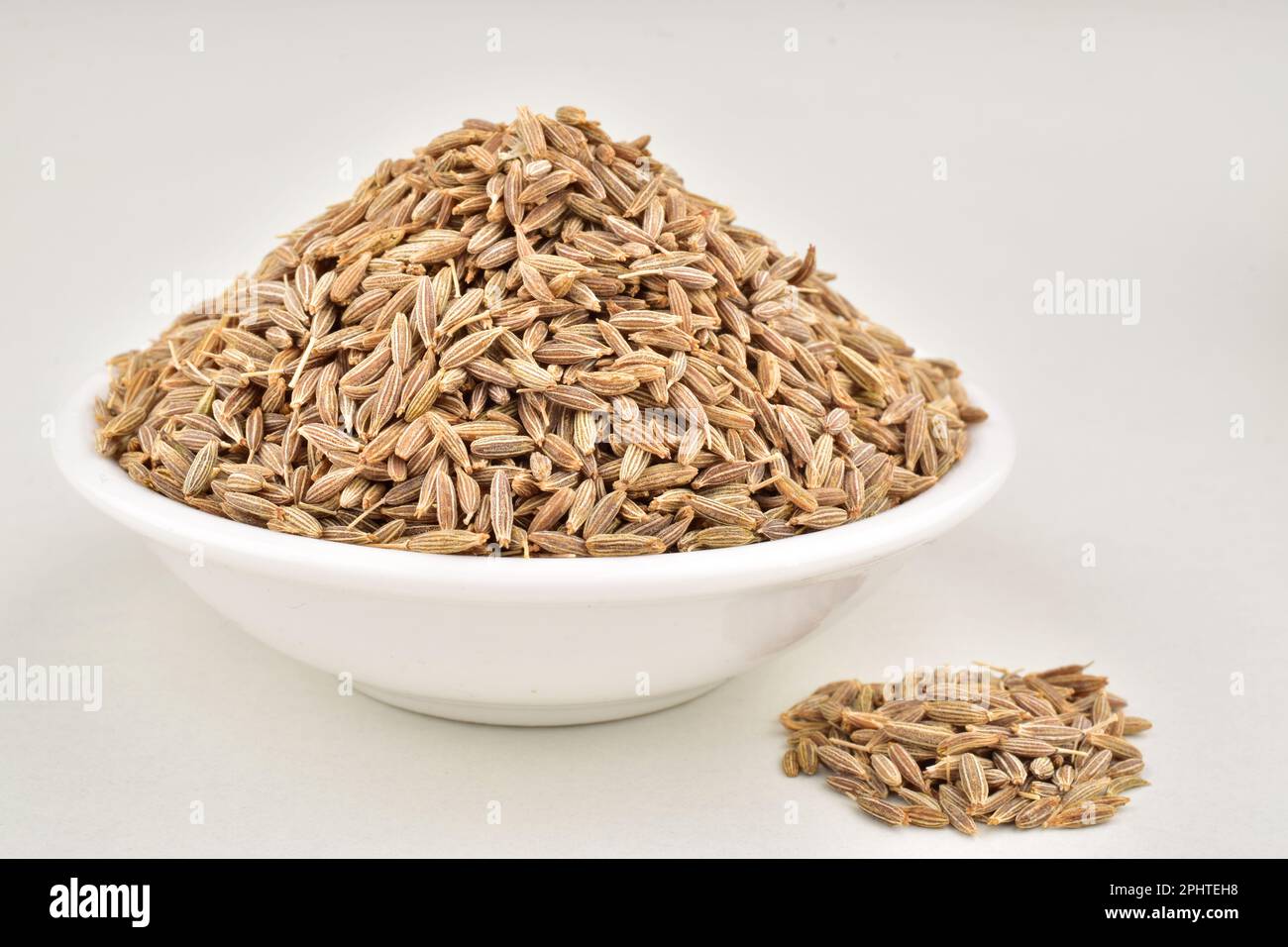Cumin seeds in bowl isolated on white background Stock Photo Alamy