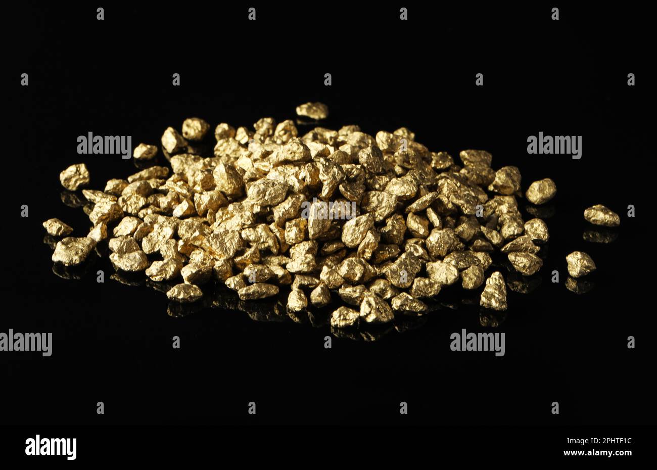 Pile of gold nuggets on black background Stock Photo - Alamy