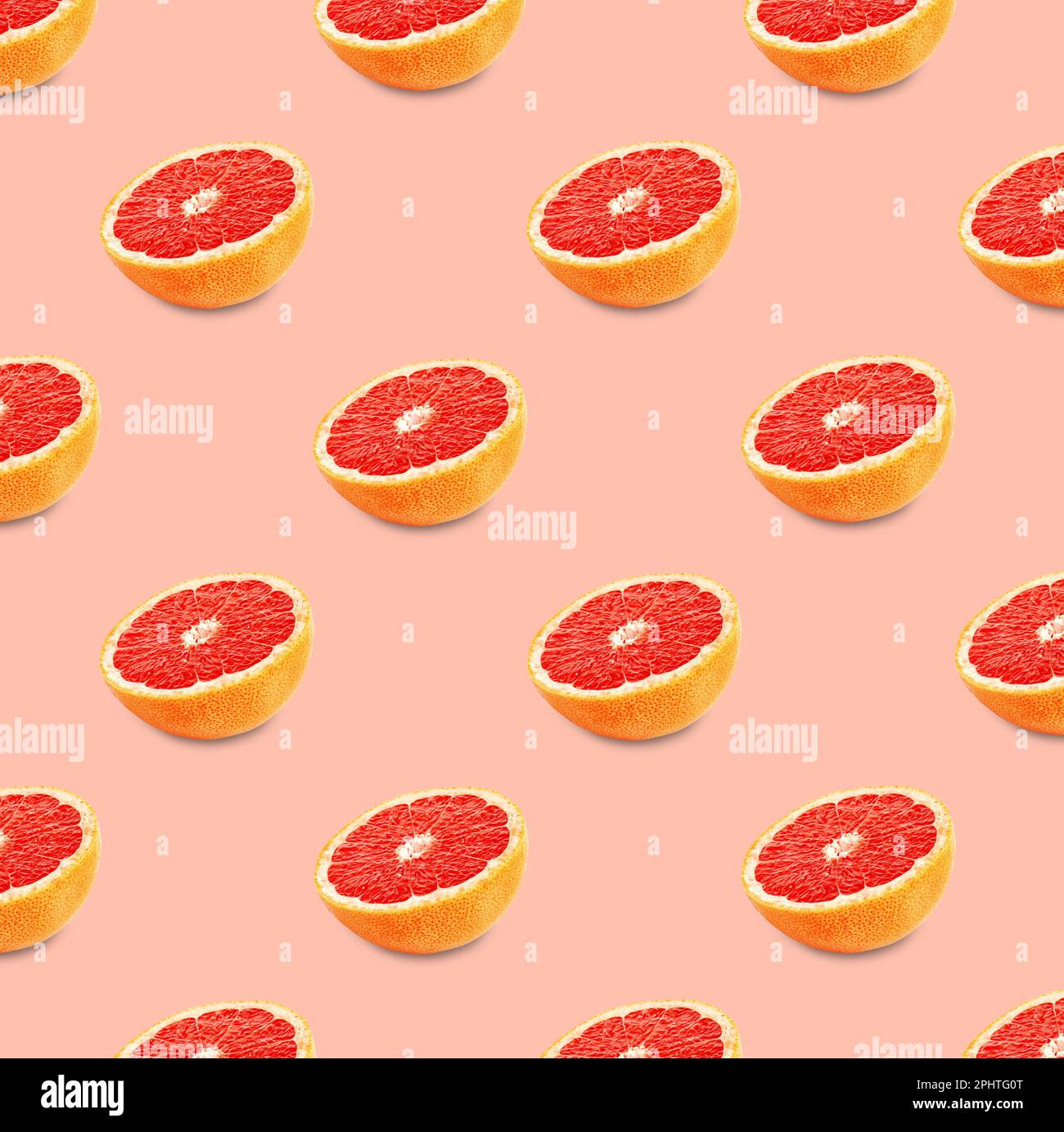 Many fresh ripe grapefruits on pink background. Seamless pattern design Stock Photo