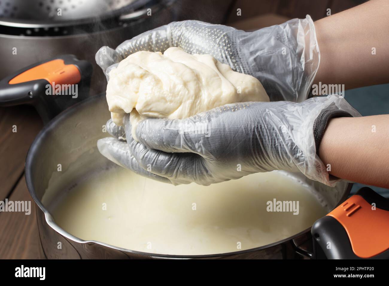 Making mozzarella cheese. Reheating the cheese curd before pulling