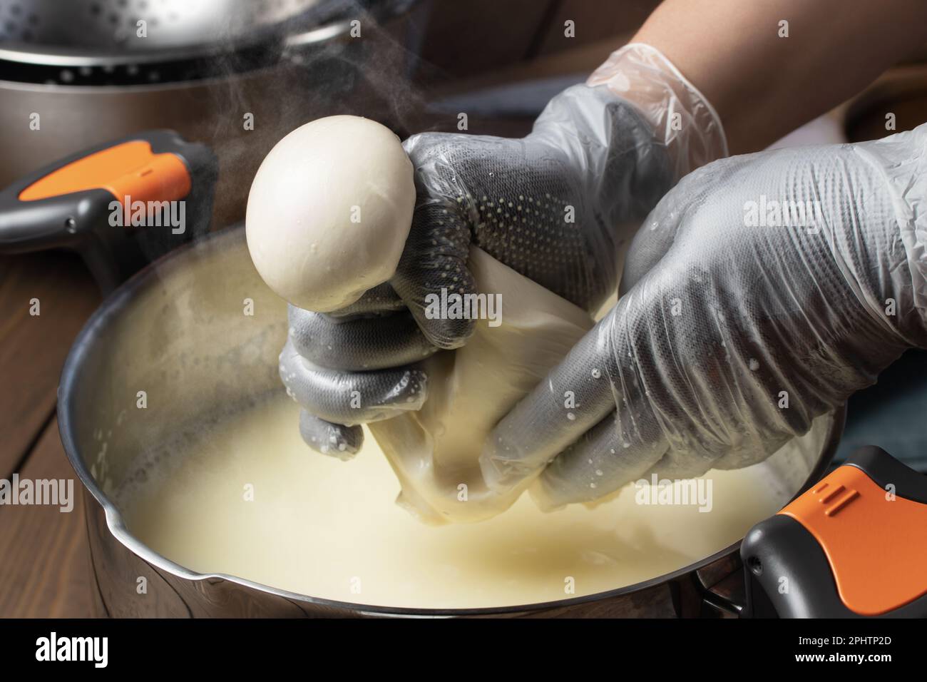 Making mozzarella cheese. Forming balls from cheese curd Stock Photo