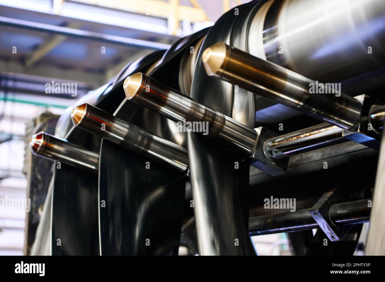 Black rubber ribbons rolled by tool at compound calendering Stock Photo ...