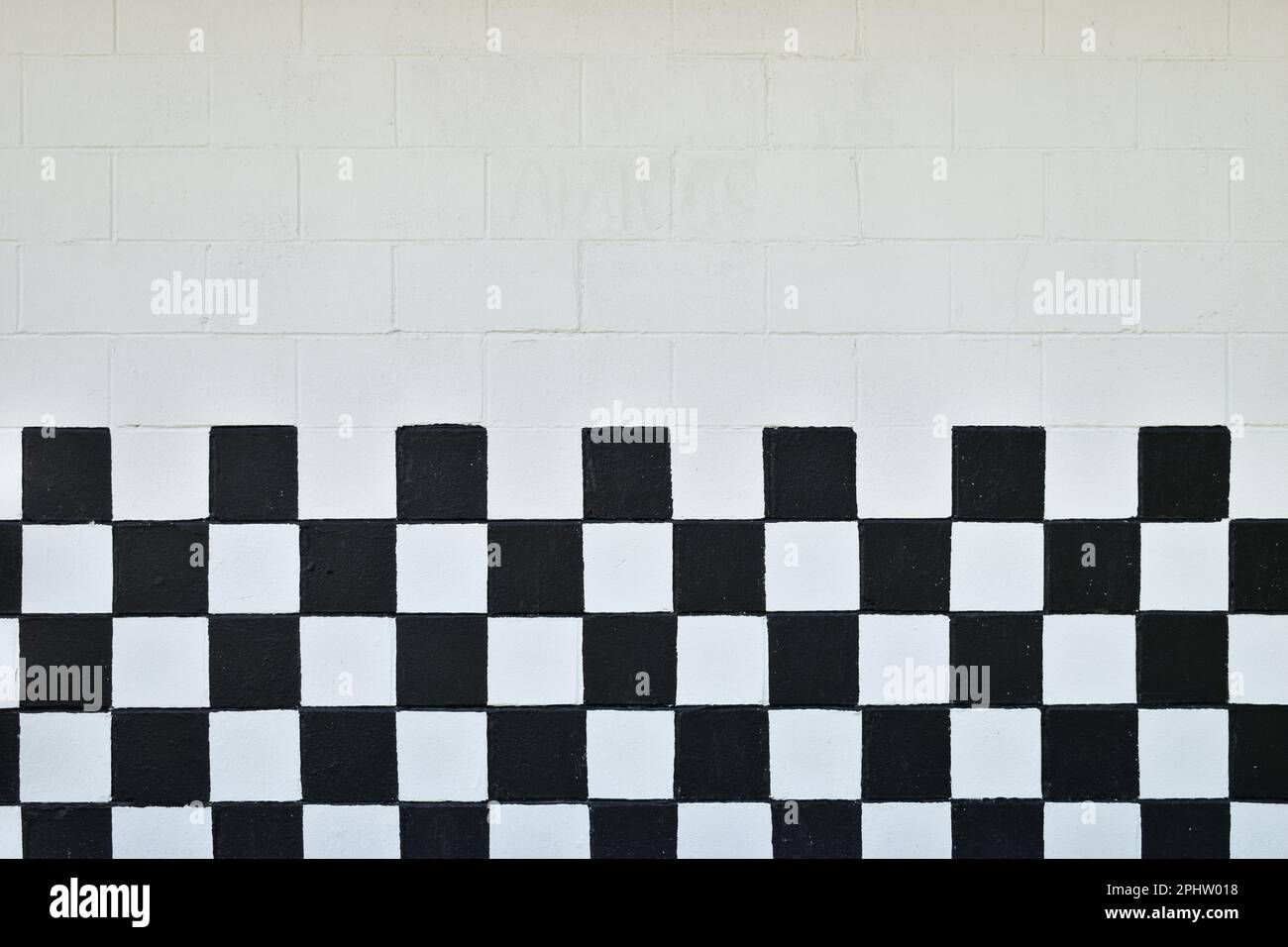 Black and white checkered cinder block wall Stock Photo