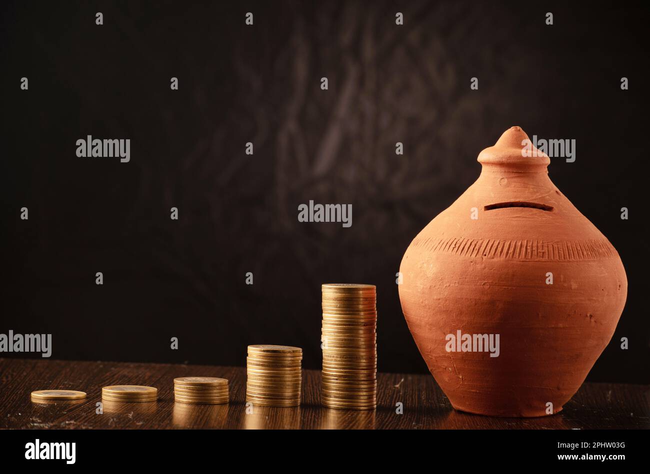 Indian money saving concept coins with gullak Stock Photo Alamy