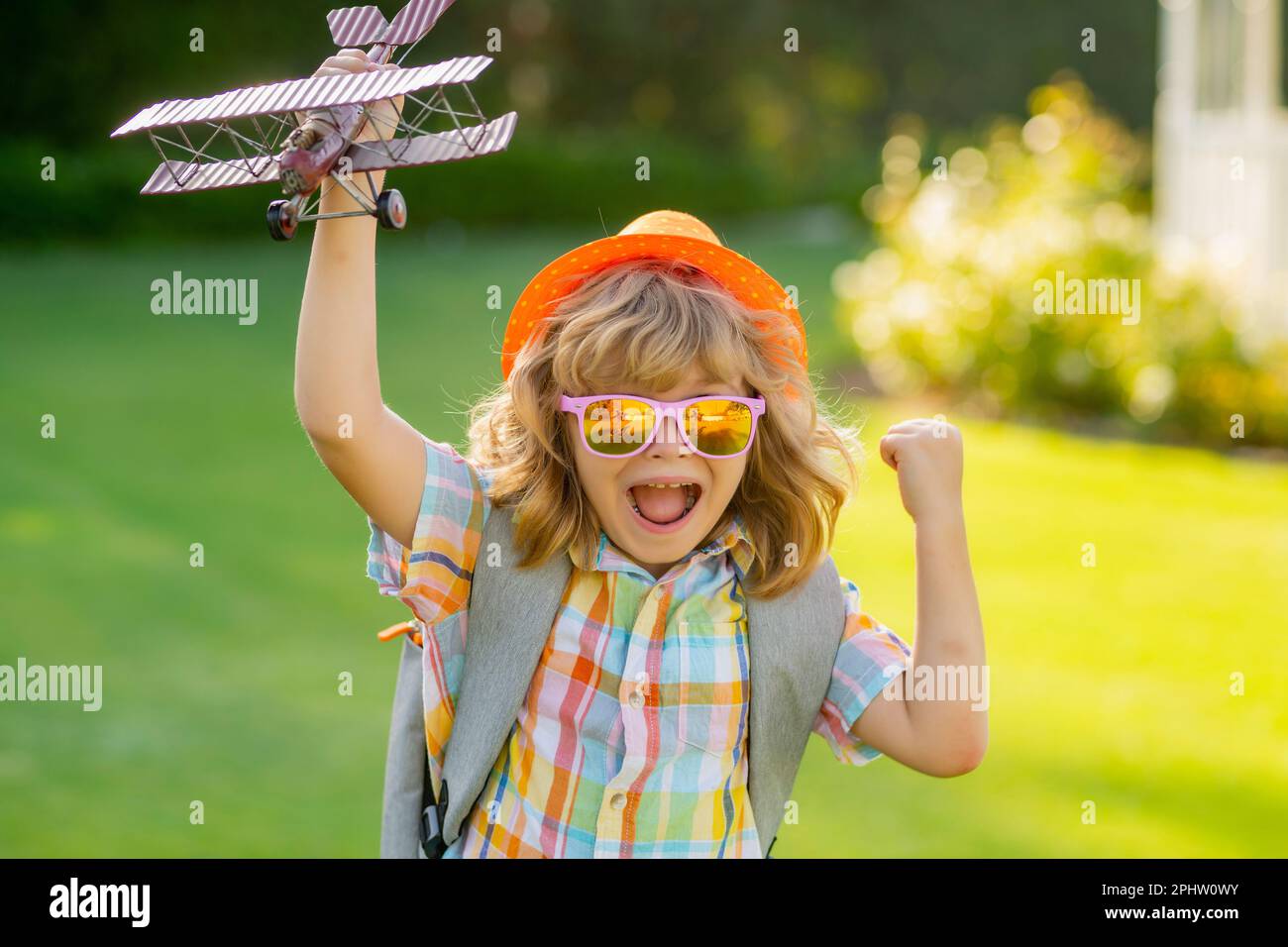 Child boy toddler playing with toy airplane wings and dreaming future ...