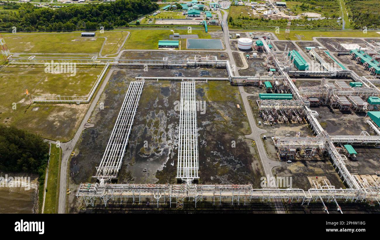 Large above ground tanks store oil and gas in an oil refinery. Borneo