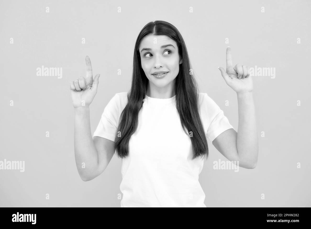 Woman point up at copy space, showing copyspace pointing. Promo, girl