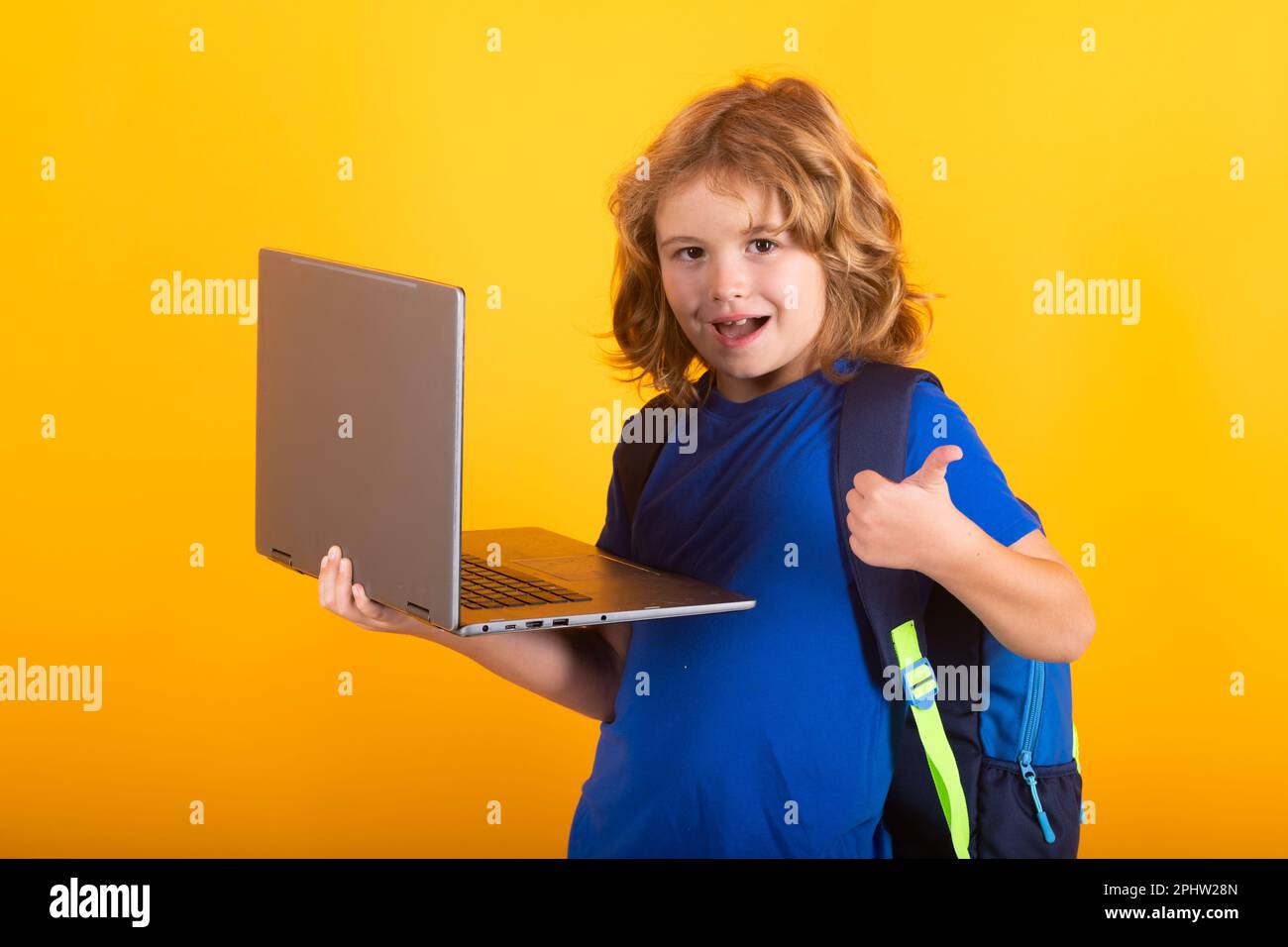 School child using laptop computer. Kid boy from elementary school with ...