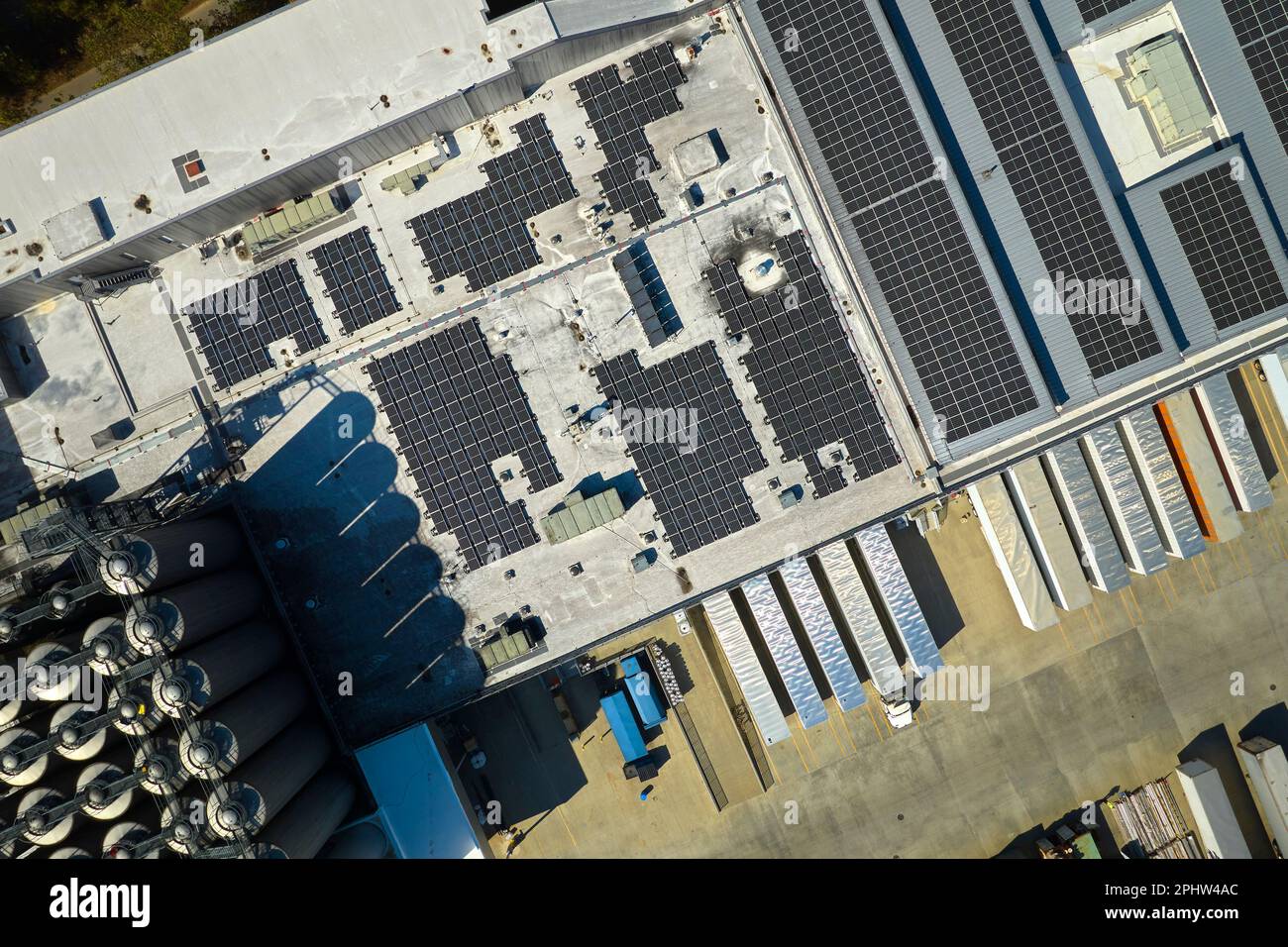 Aerial view of blue photovoltaic solar panels mounted on industrial ...