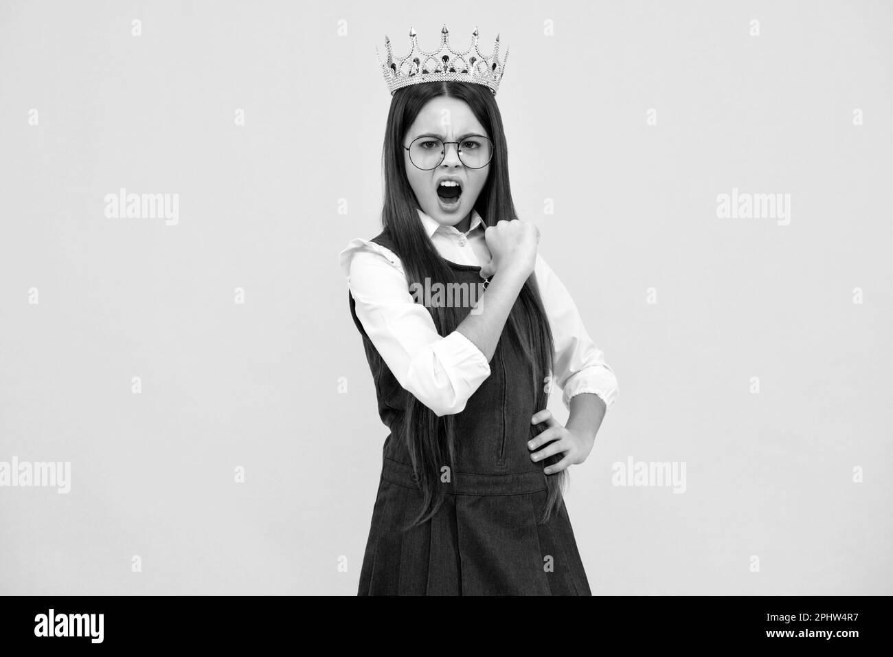Girls party, funny kid in crown. Child queen wear diadem tiara. Cute little princess portrait. Angry teenager girl, upset and unhappy negative emotion Stock Photo