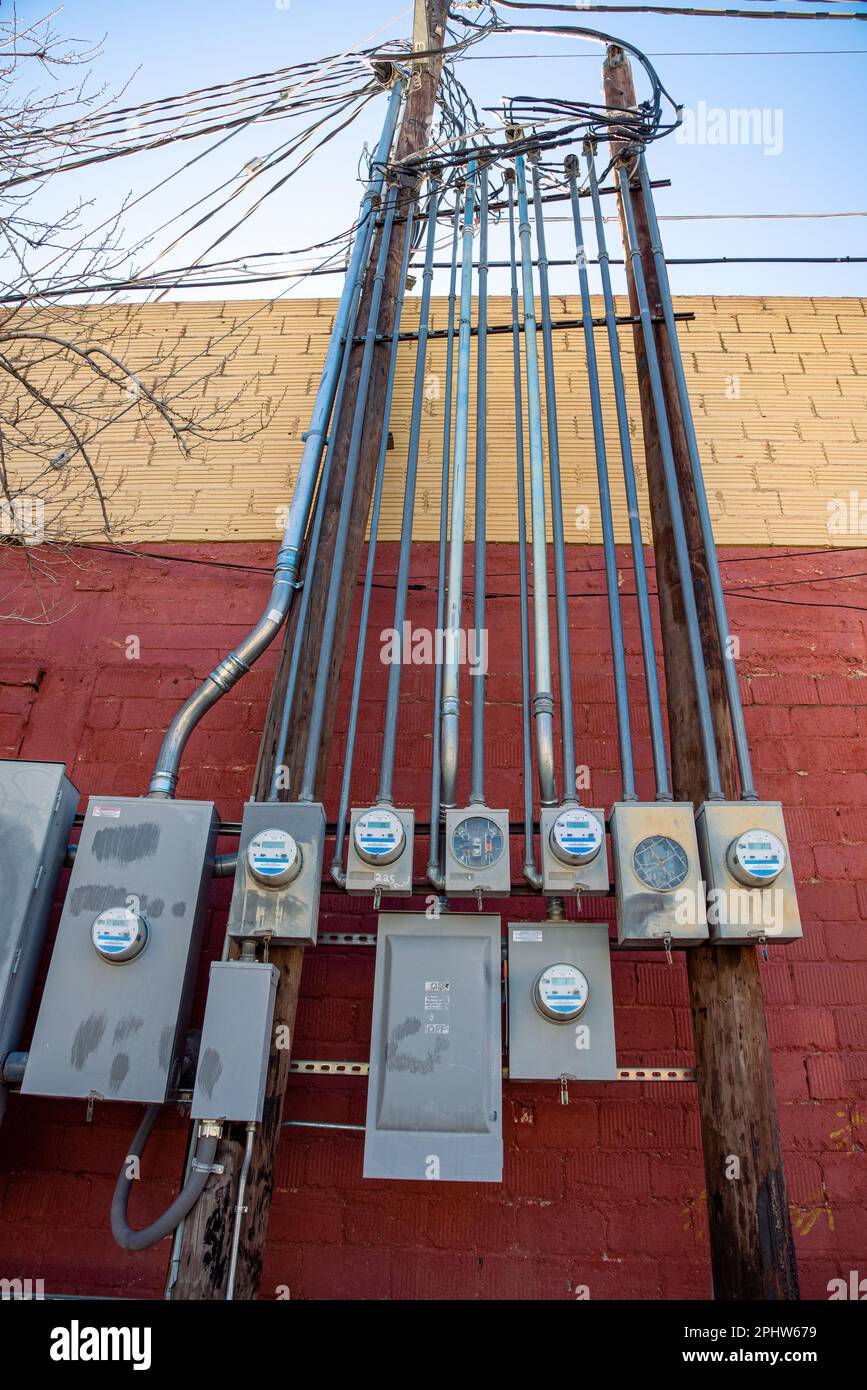 A group of analogue electrical meters with conduit connecting to power