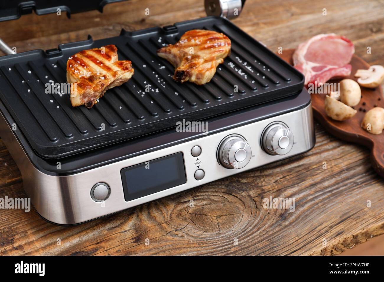 grilling chicken with spices on the electric grill in the home kitchen  Stock Photo - Alamy