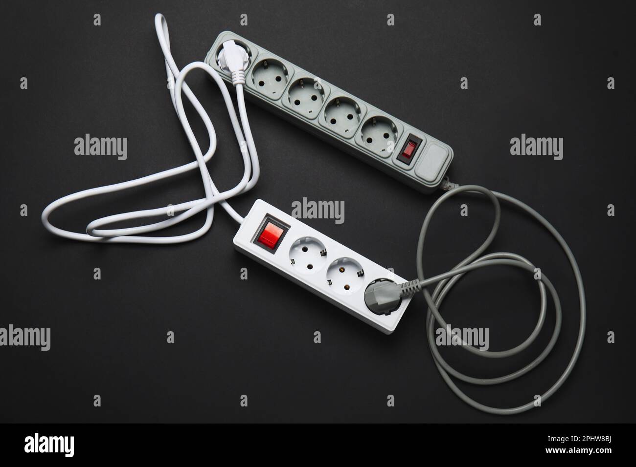 Electric extension cords on black background Stock Photo