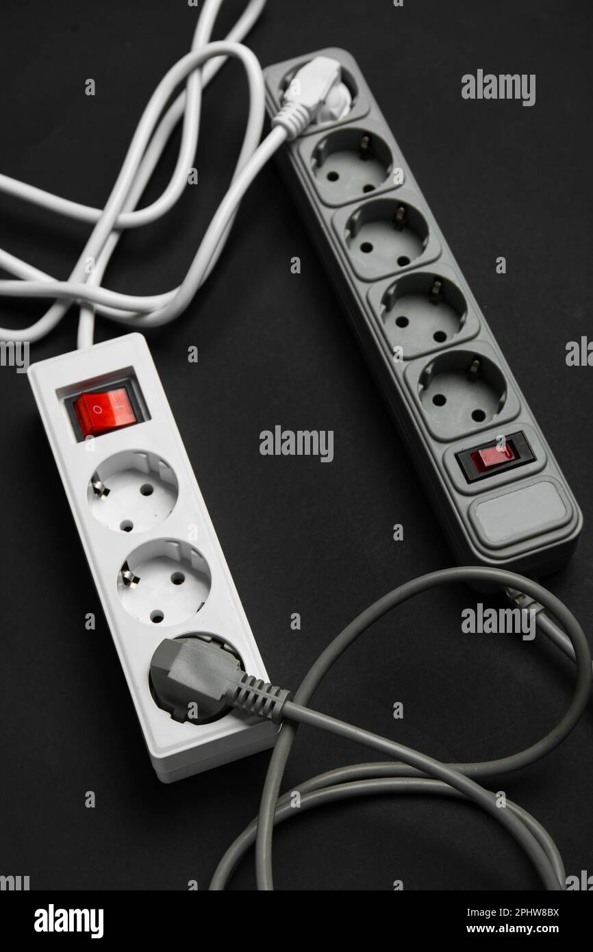 Electric extension cords on black background Stock Photo