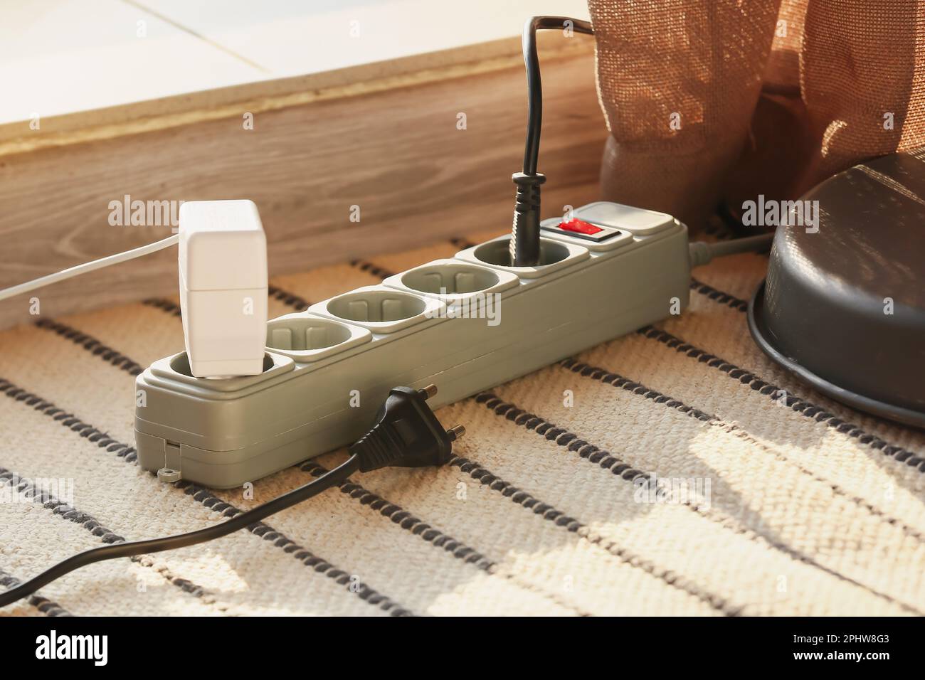 Electric extension cord with plugs on carpet Stock Photo Alamy