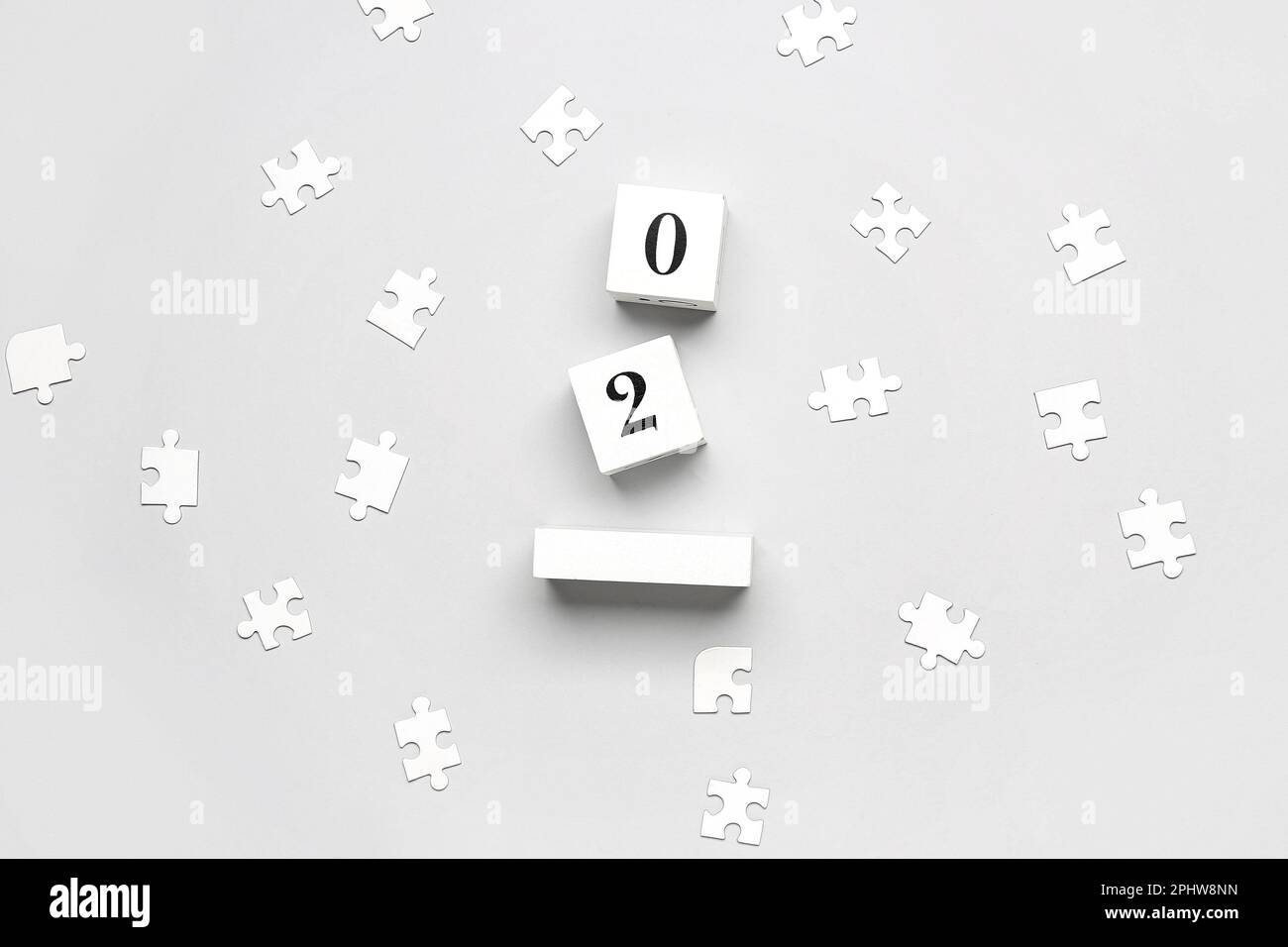 Date of World Autism Awareness Day with puzzle pieces on grey