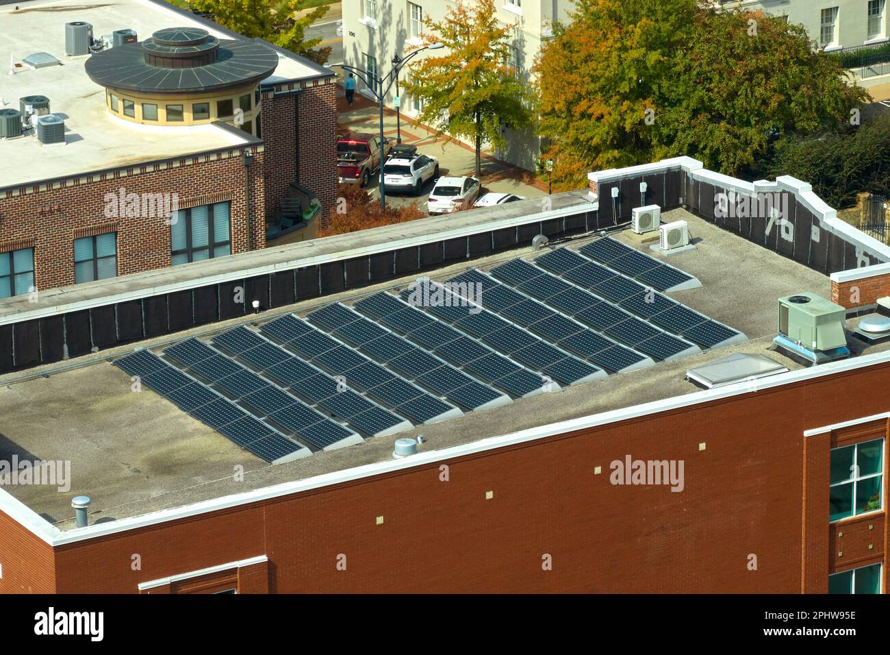 Blue photovoltaic solar panels mounted on residential building roof for ...