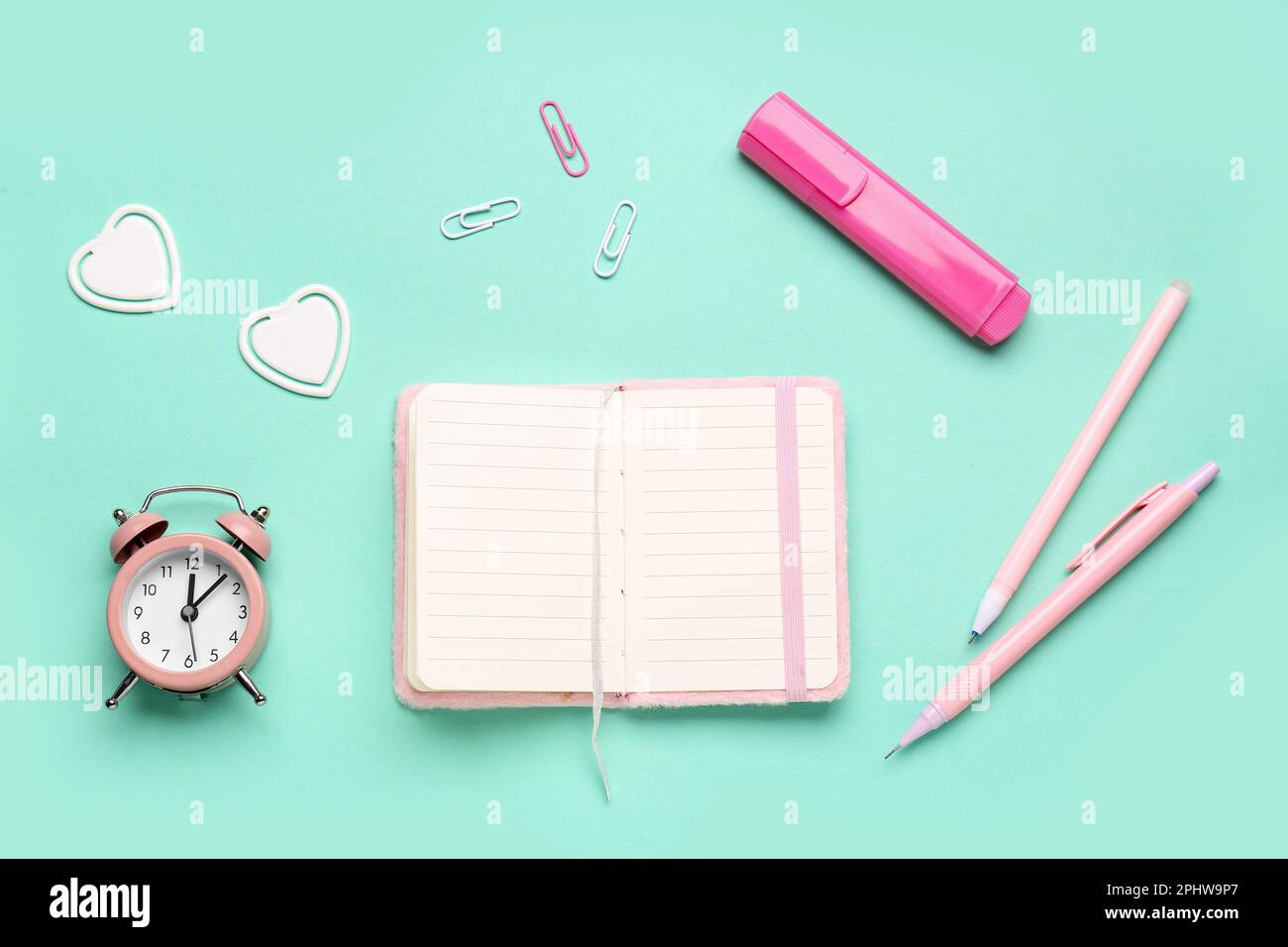 Composition with blank notebook, pins and clock on turquoise background ...