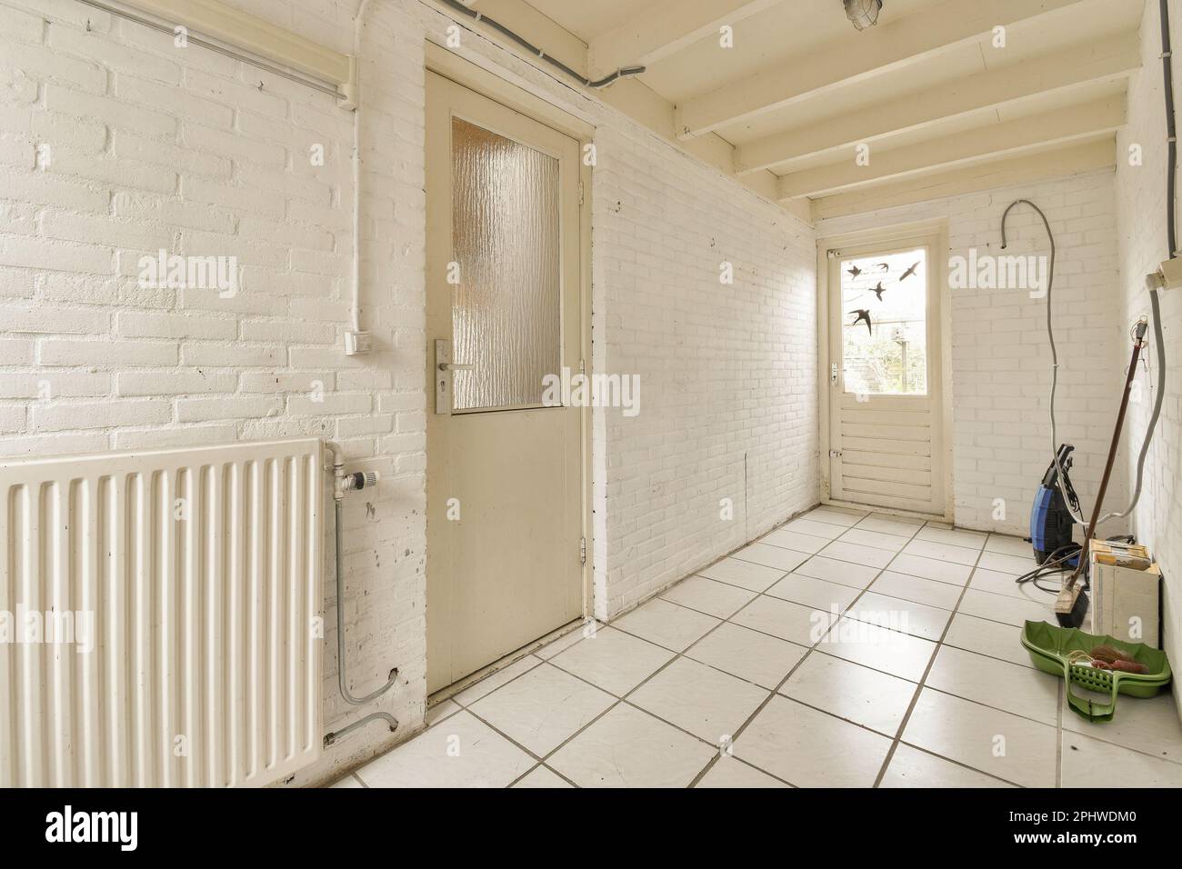 an empty room with white bricks on the walls, and a radiator in the ...