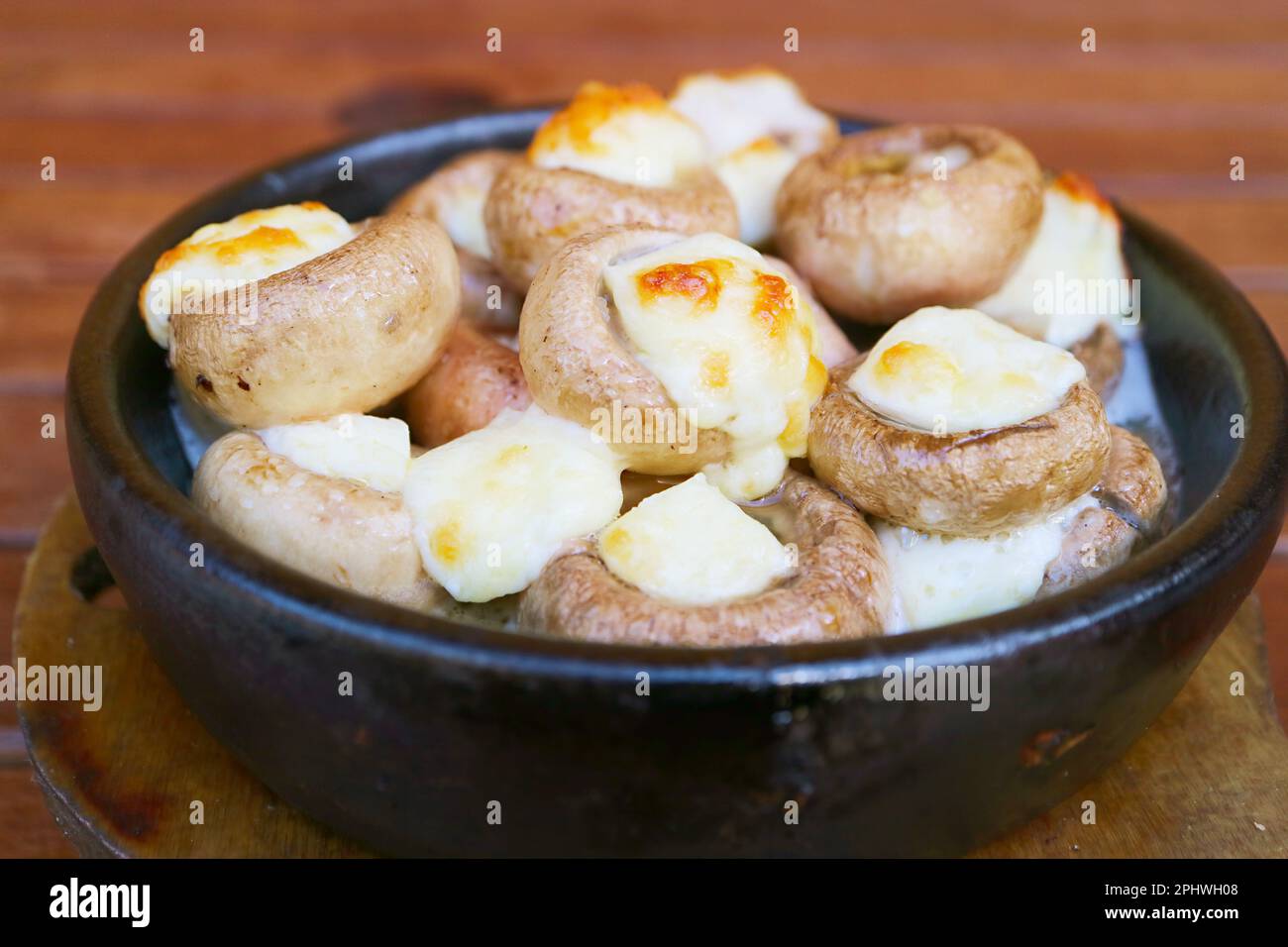 Delectable Soko Ketze, a Georgian Stuffed Mushrooms with Sulguni Cheese Baked in a Ketsi Clay Bowl Stock Photo