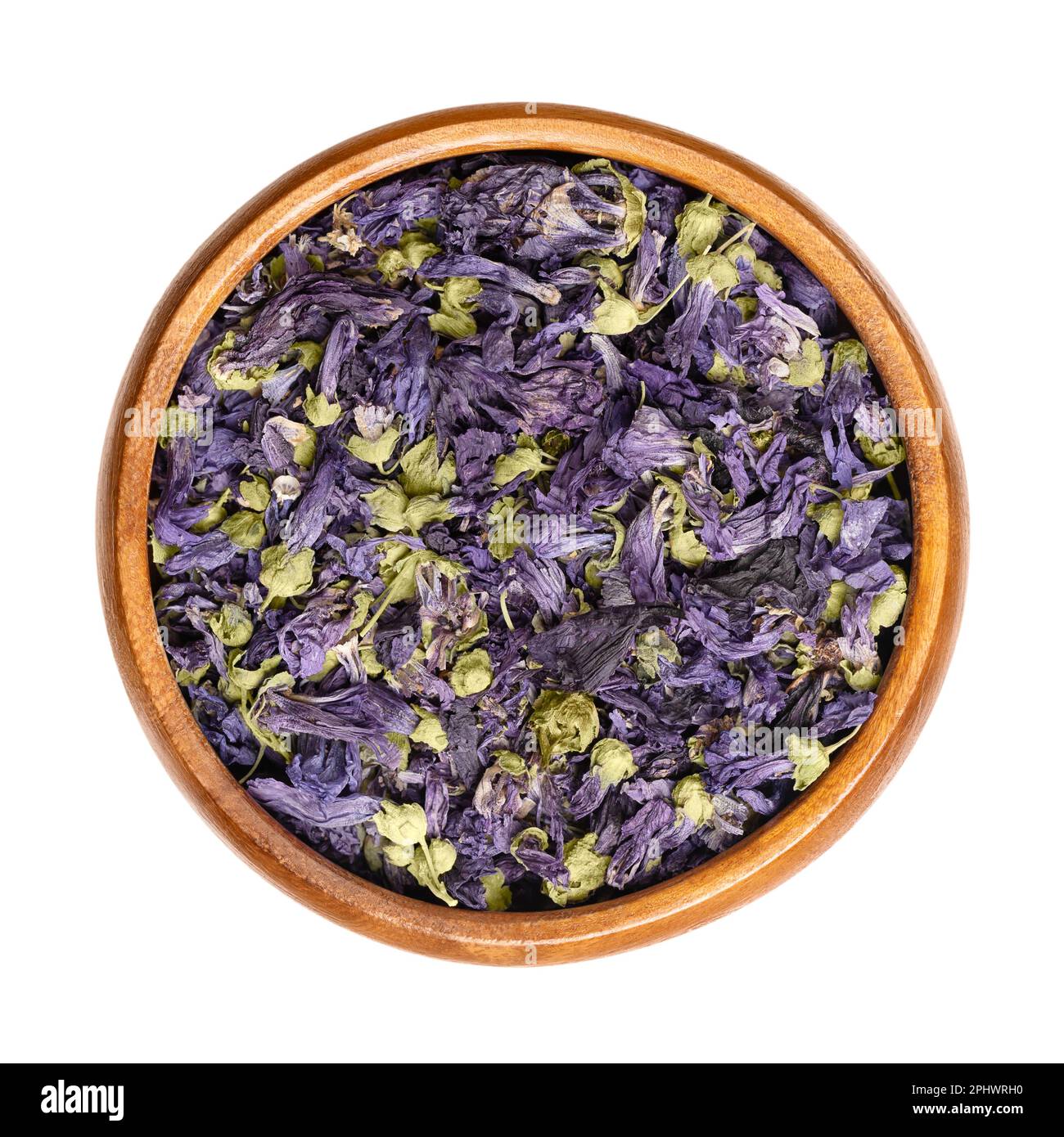 Dried purple mallow tea flowers, in a wooden bowl. Mauve-purple flower heads of Malva sylvestris, also known as common mallow, used for herbal tea. Stock Photo
