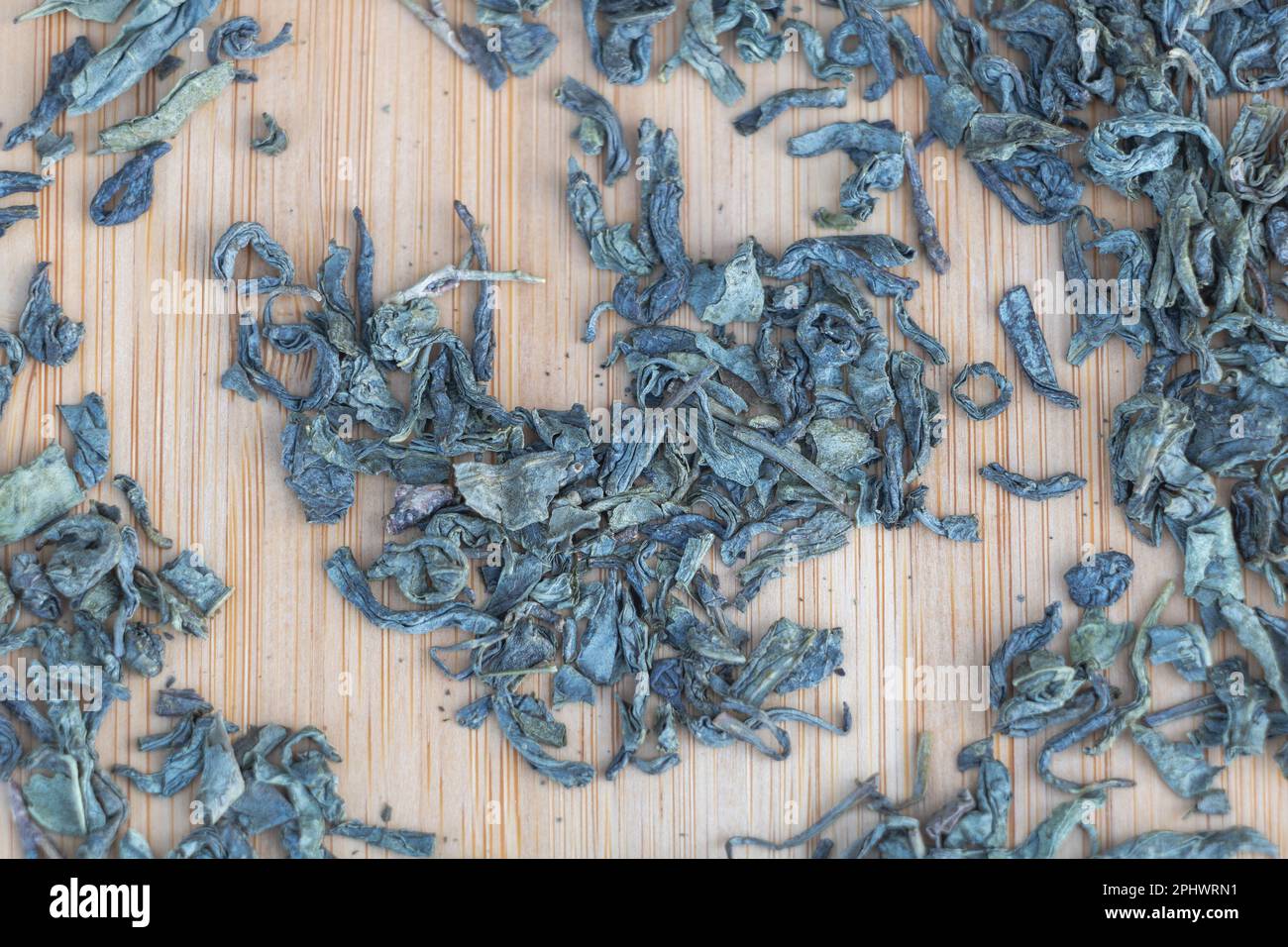 Dry tea leaves on a wooden background. Close up. Top view Stock Photo