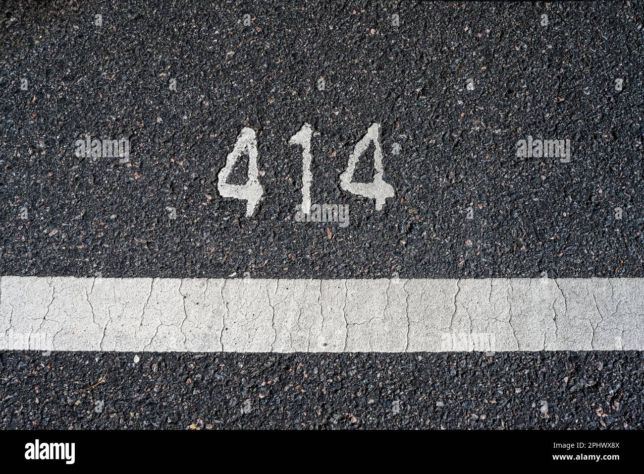 Asphalt with number 414 in white paint Stock Photo - Alamy
