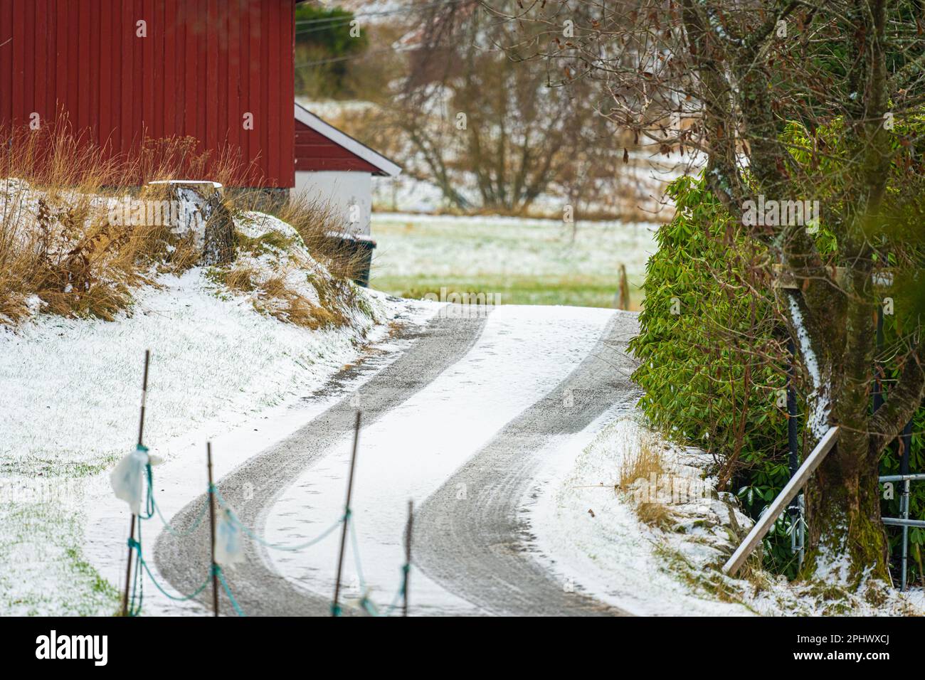 Tyre tracks on an icy road over a small hill Stock Photo - Alamy